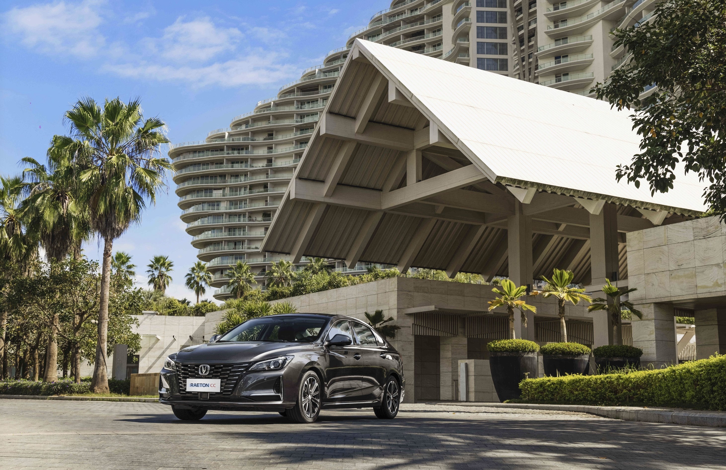 Changan Raeton CC car parked in front of a modern building HD Wallpaper