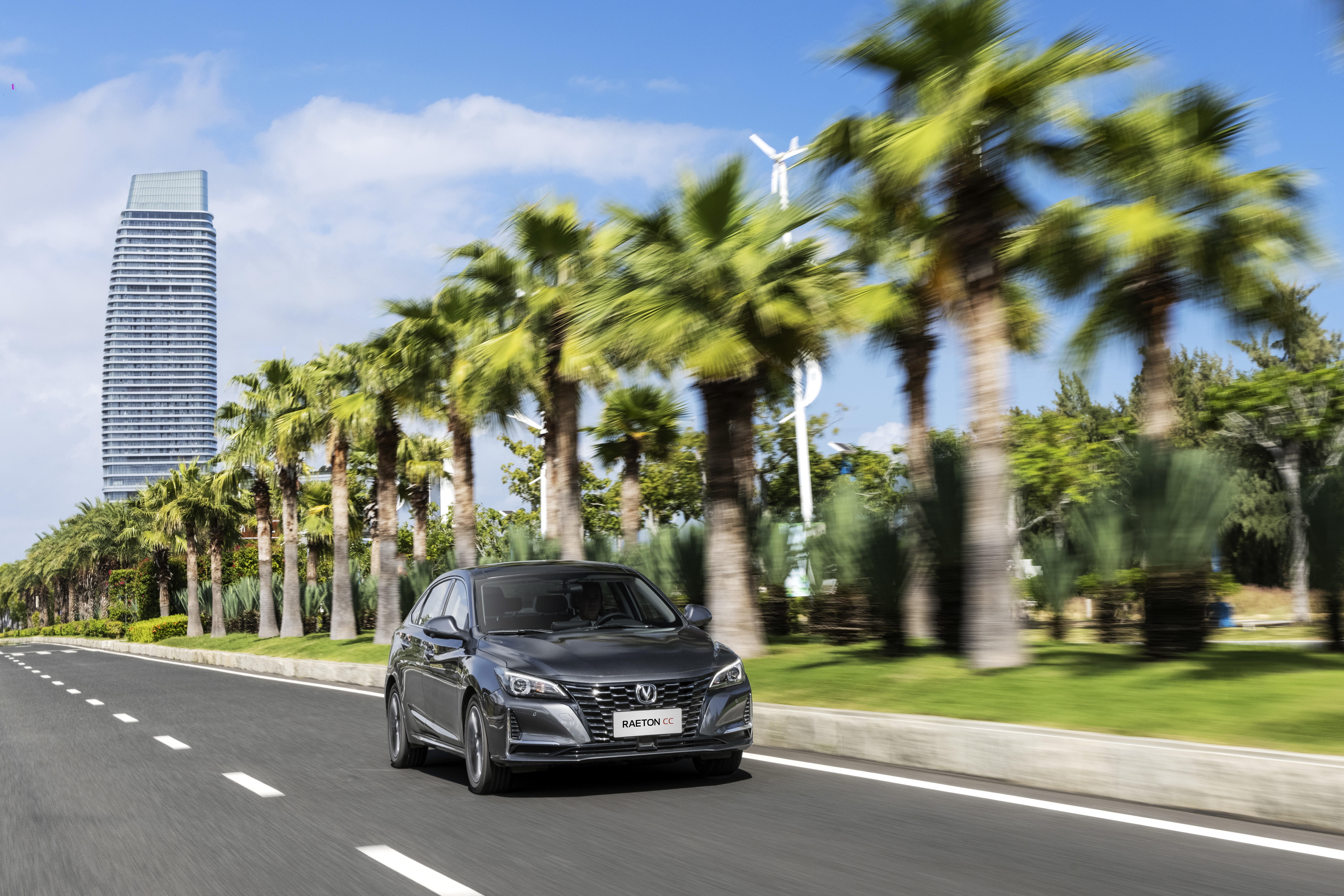 Changan Raeton CC driving on a road with palm trees HD Wallpaper