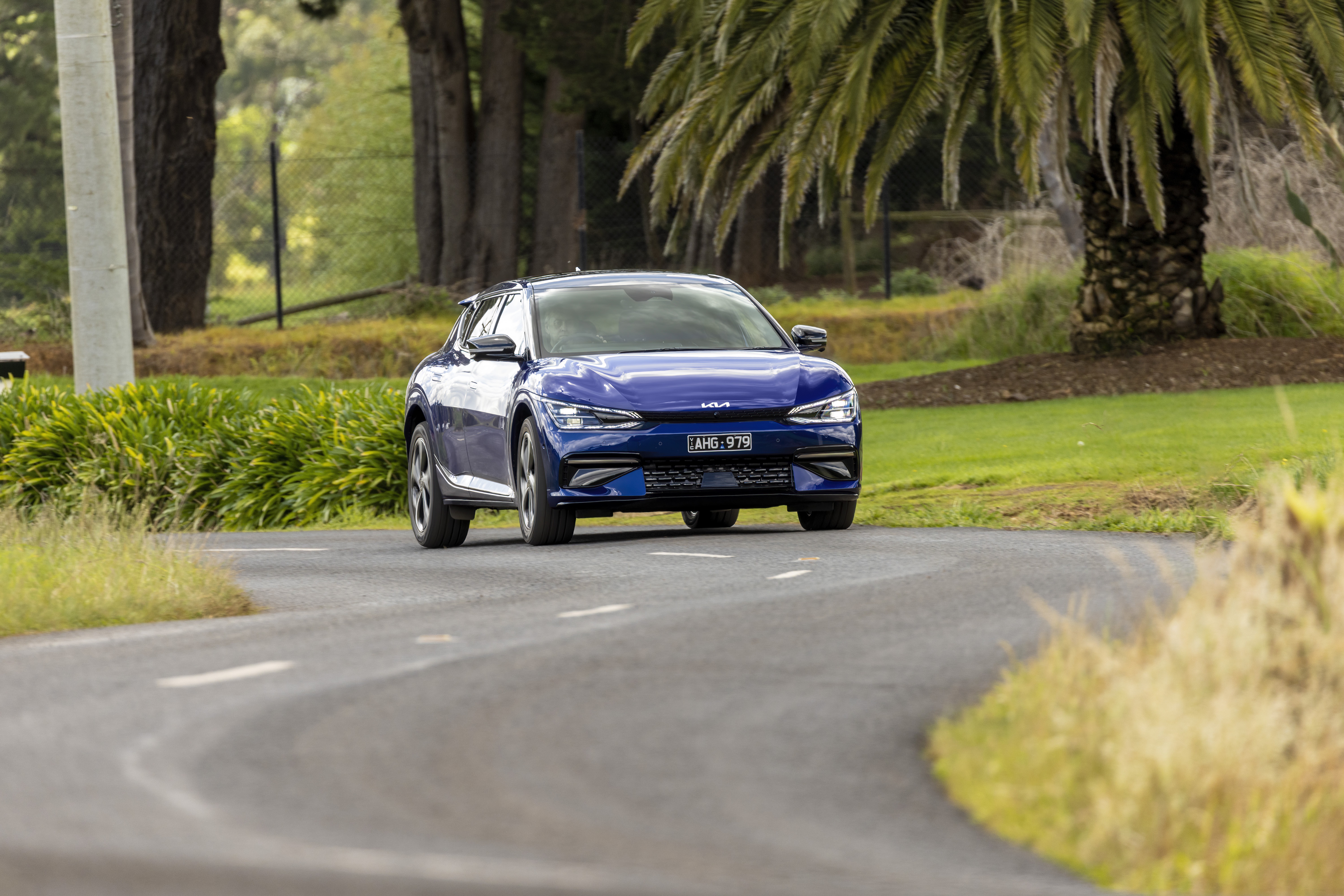 Blue Kia EV6 GT Line driving on a road HD Wallpaper