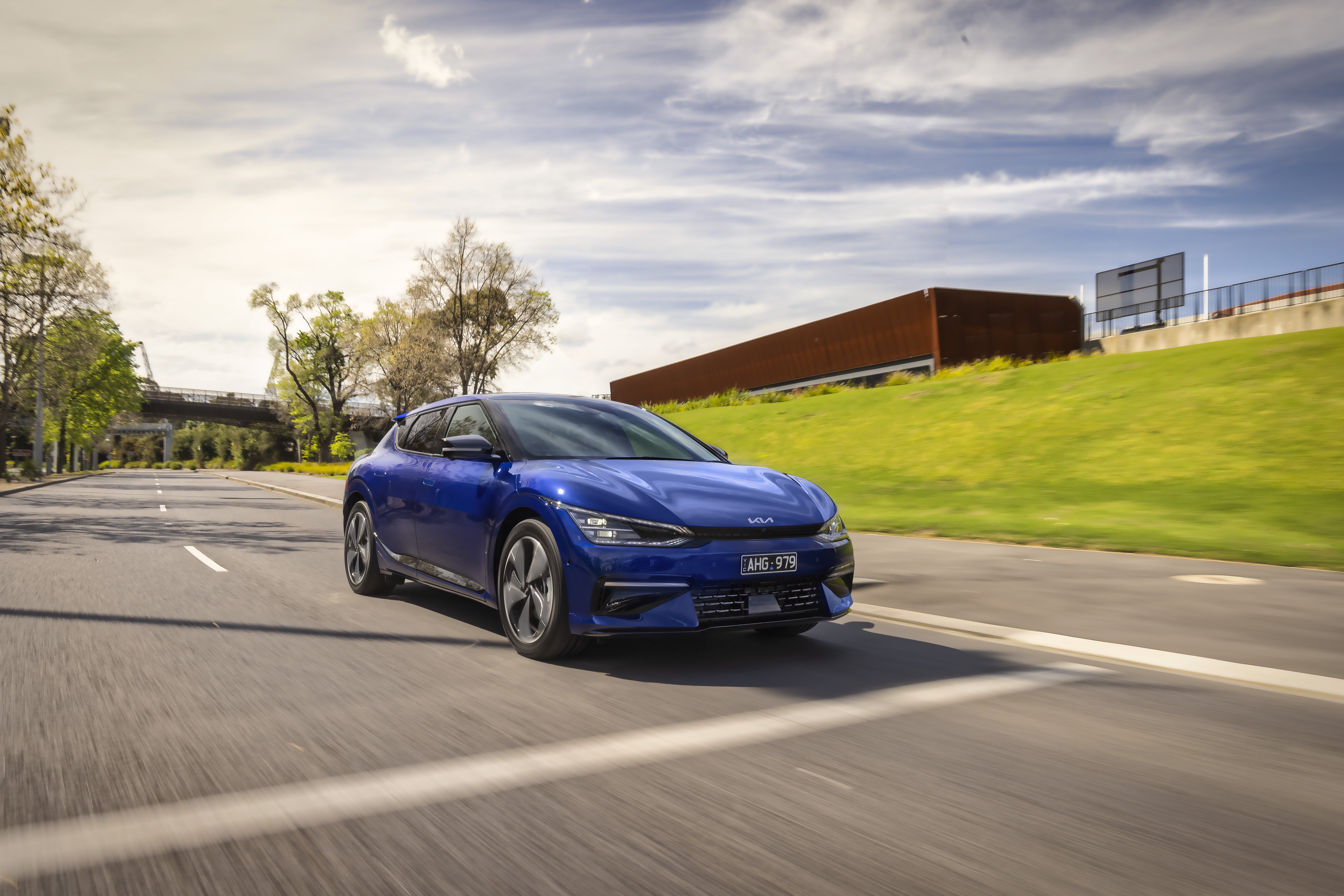 Blue Kia EV6 GT Line driving on a road HD Wallpaper
