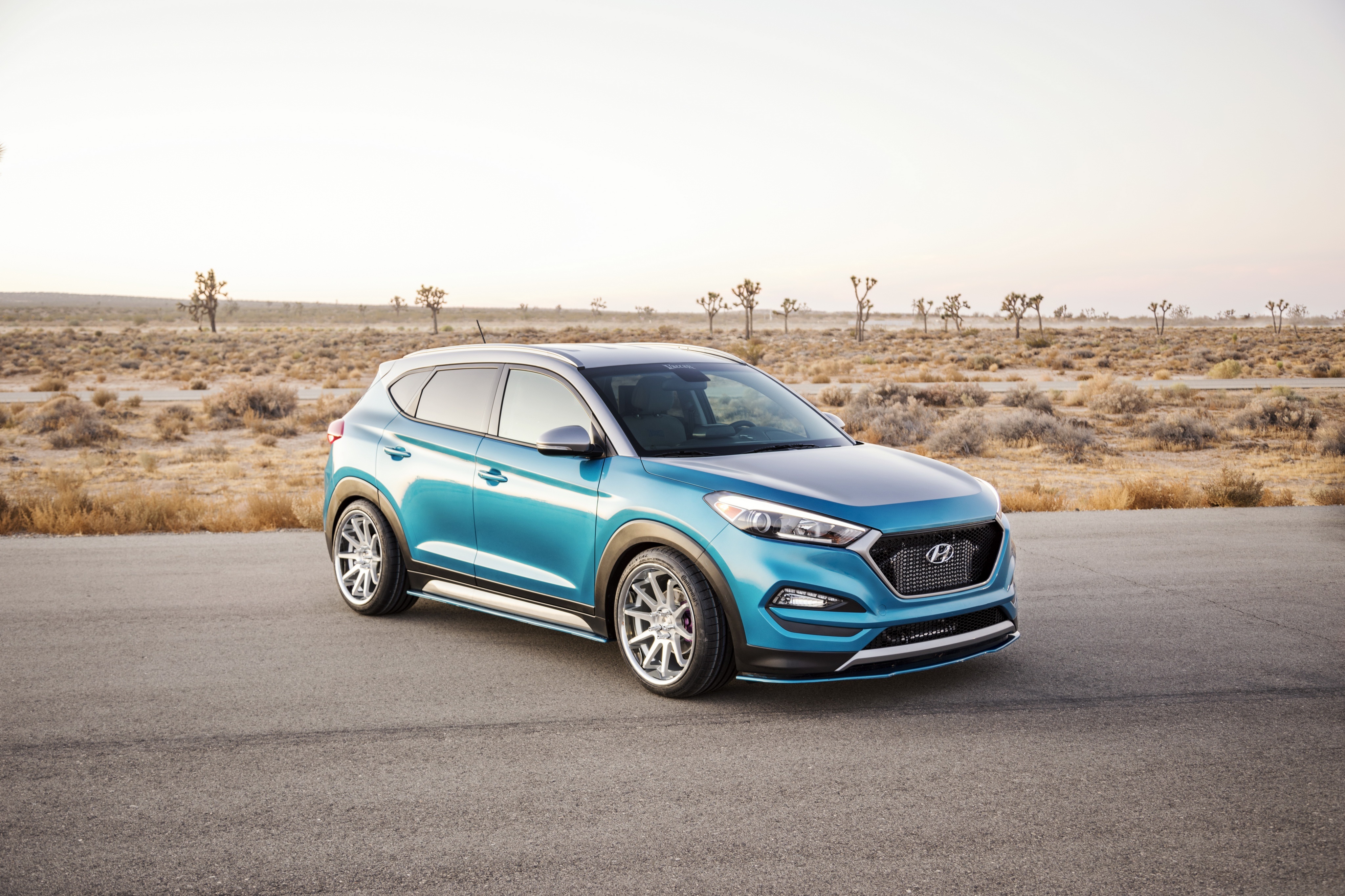 Blue Hyundai Tucson SUV in Desert Landscape HD Wallpaper