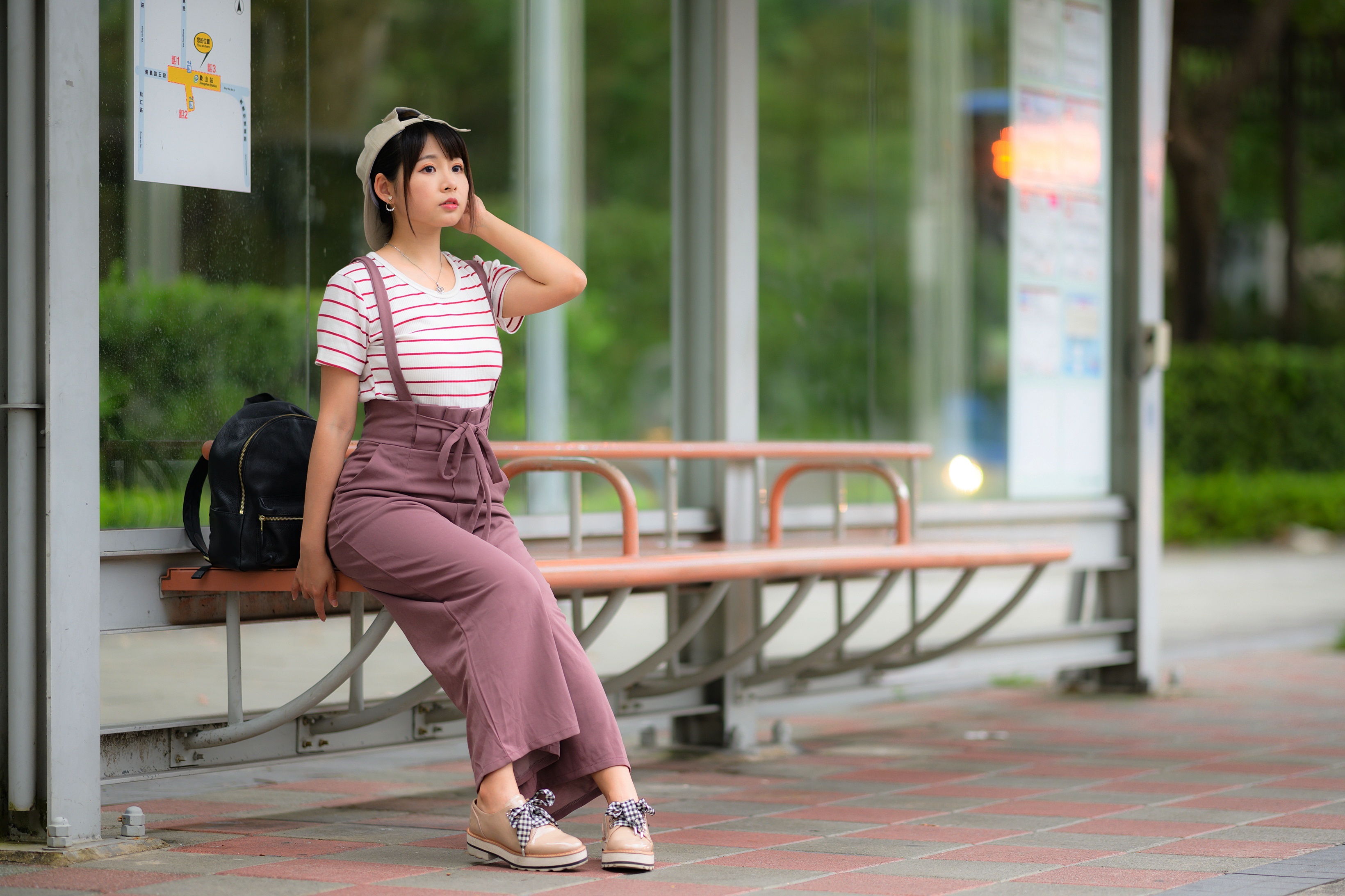 Young Asian woman at bus stop HD Wallpaper