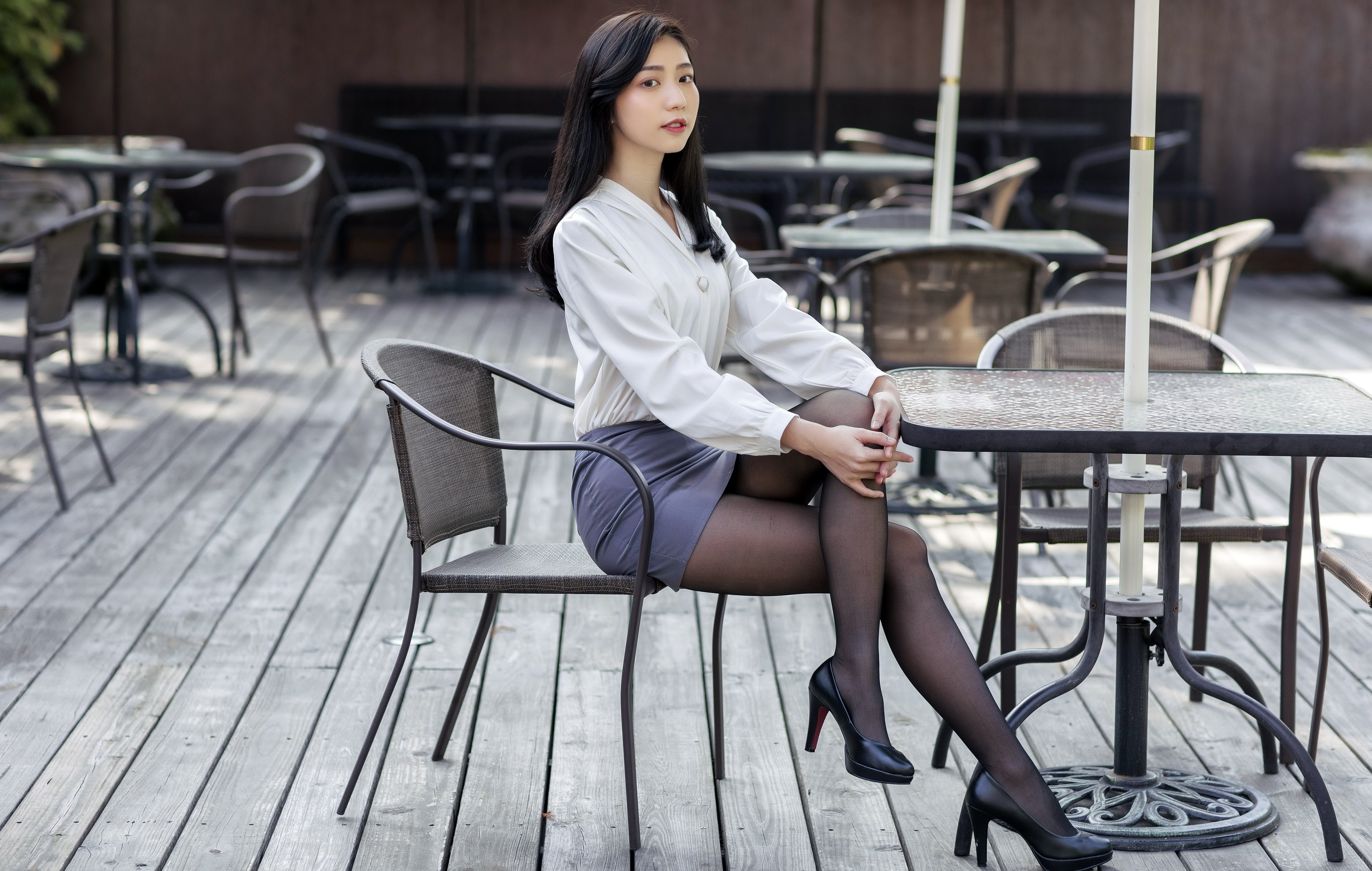 Asian woman with black hair sitting at a table HD Wallpaper