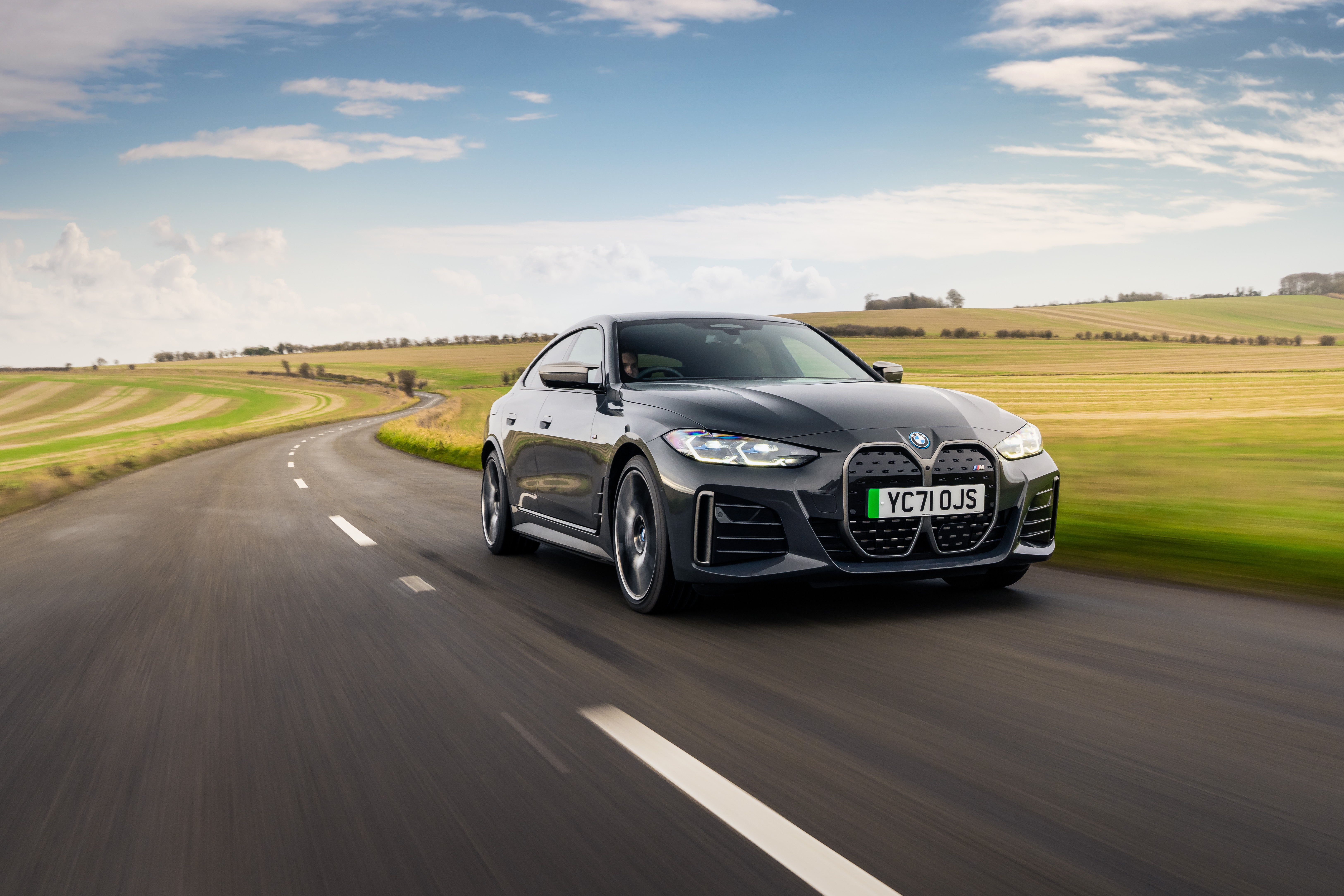BMW i4 M50 driving on a country road HD Wallpaper