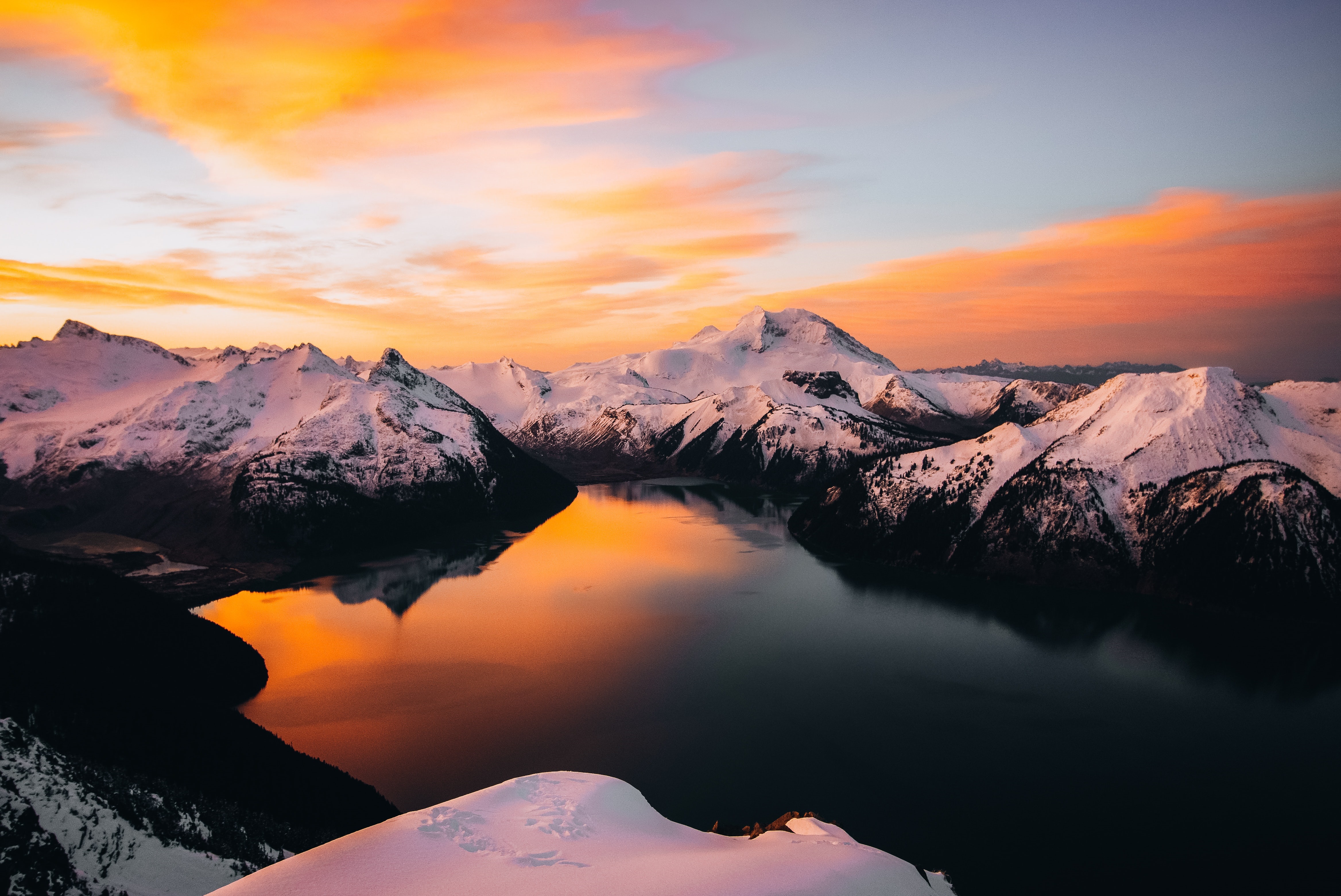Sunrise over snow-capped mountains and a lake HD Wallpaper