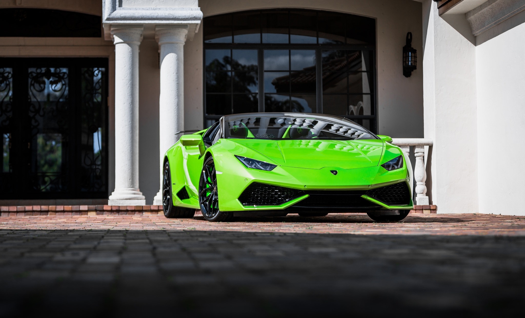 Green Lamborghini Huracan parked in front of a house HD Wallpaper