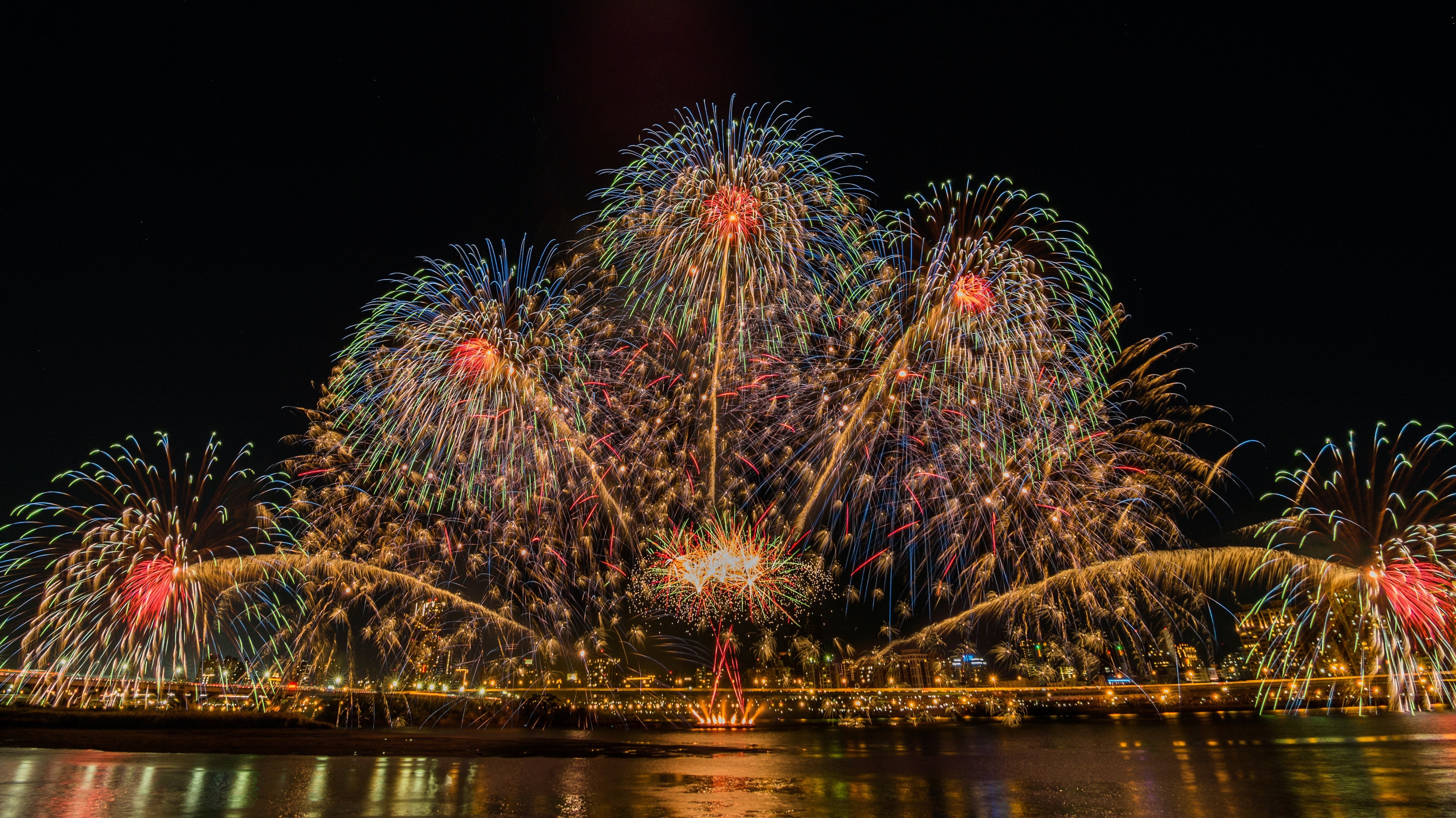 Fireworks Display Over City at Night 4K HD Wallpaper