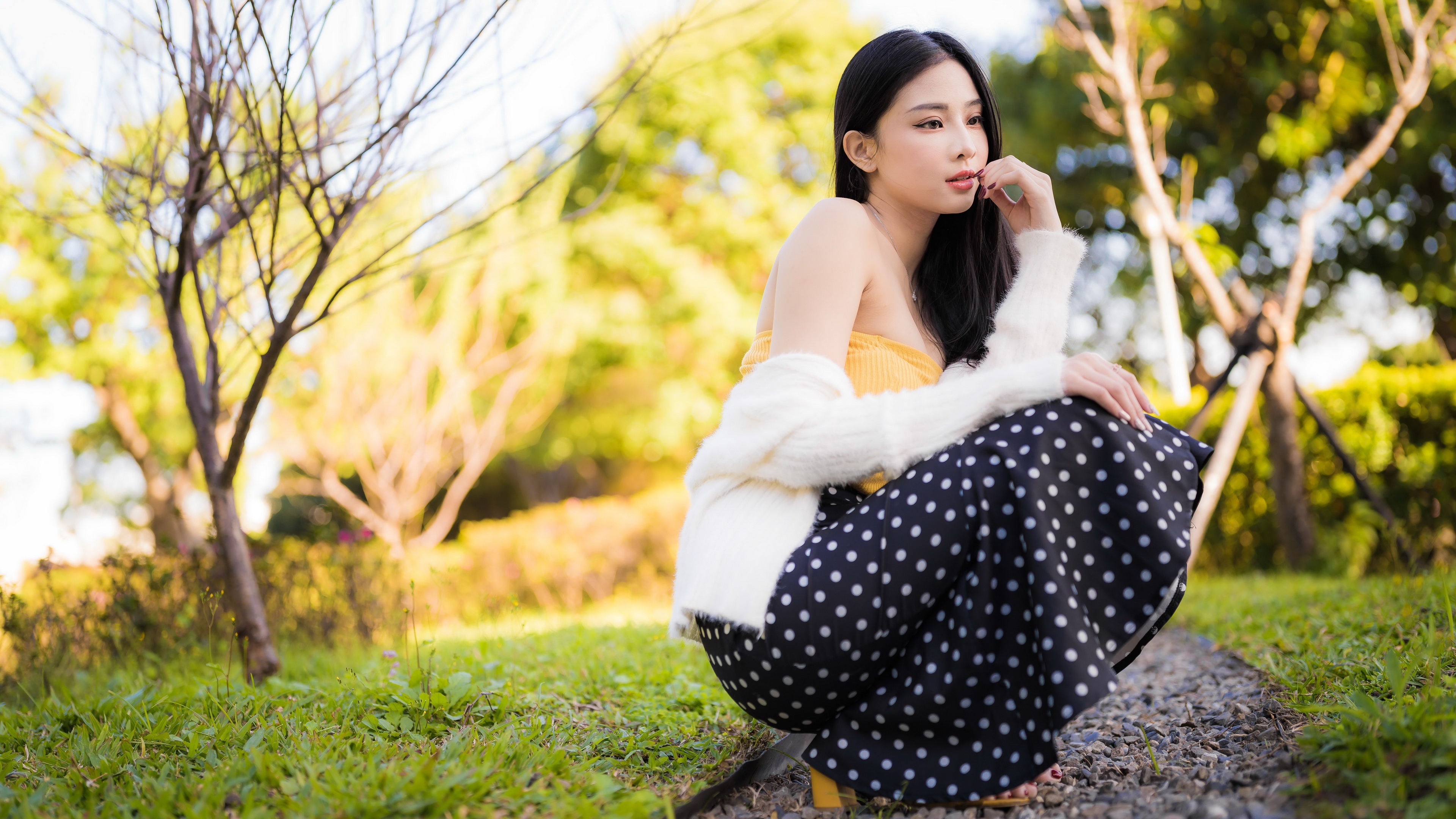 Asian woman in polka dot skirt in park 4K HD Wallpaper