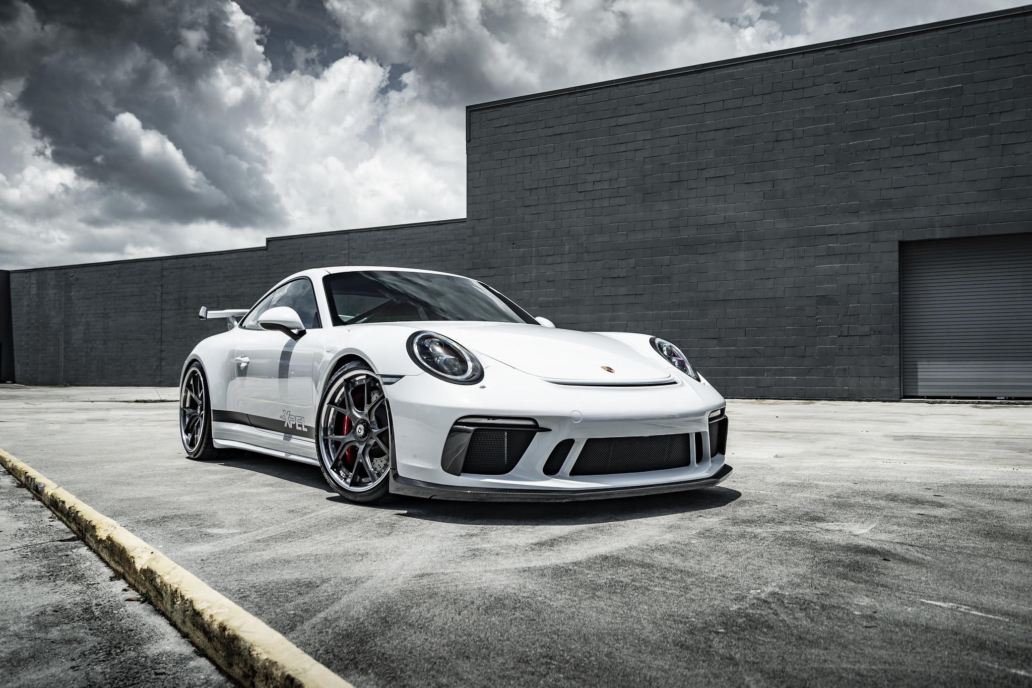 White Porsche 911 GT3 RS parked in front of a brick building HD Wallpaper