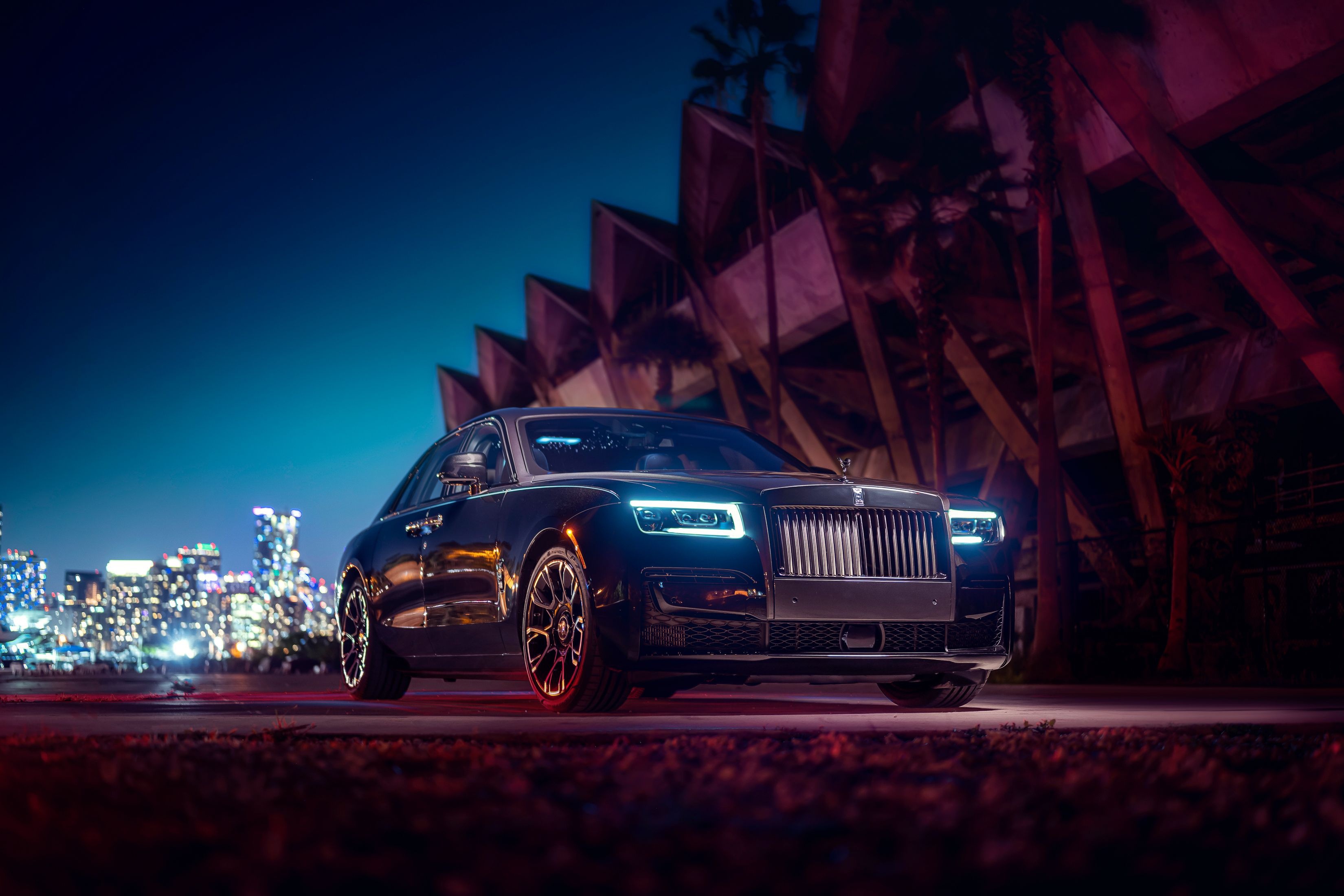 Rolls-Royce Ghost parked at night with city skyline HD Wallpaper