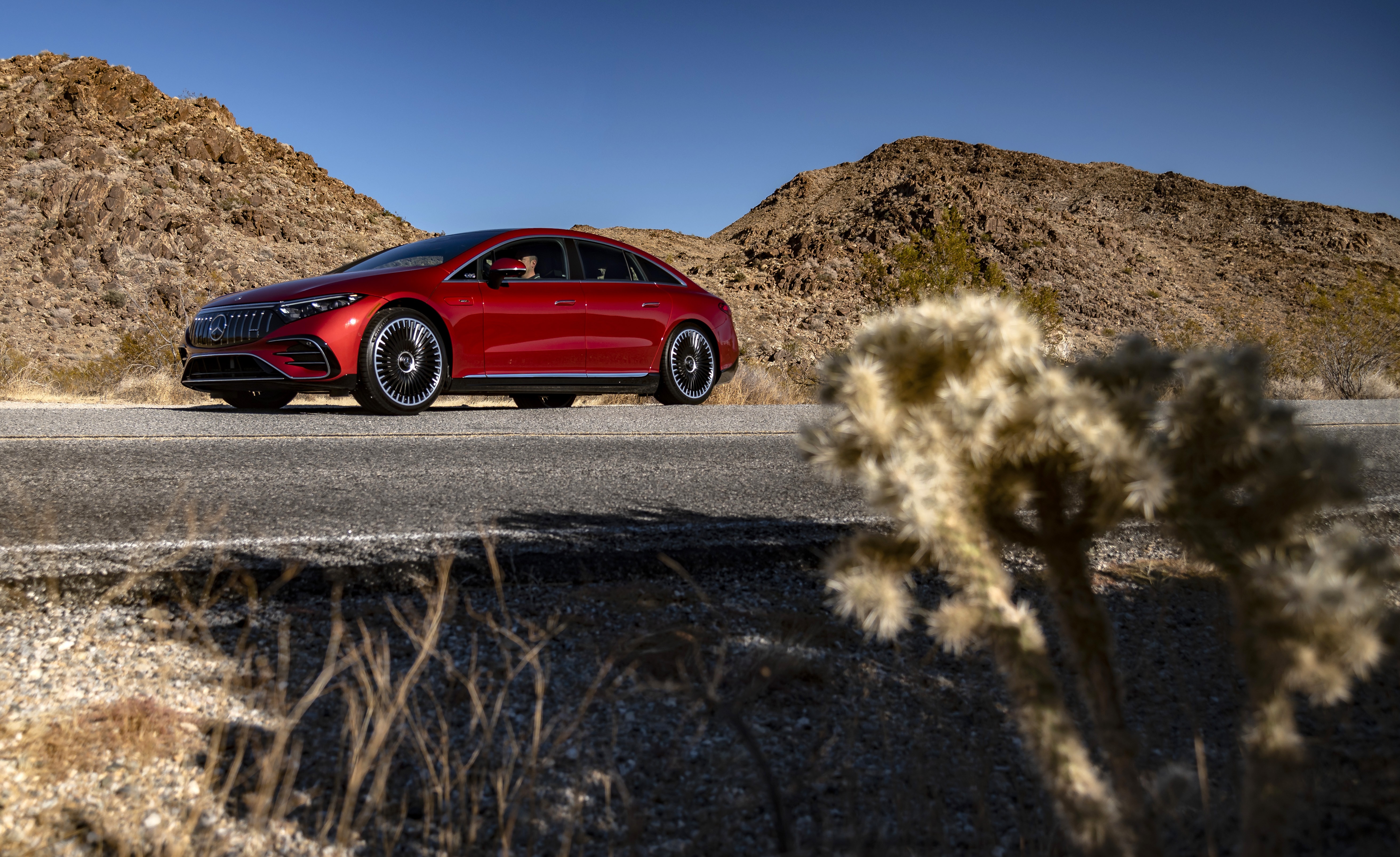 Red Mercedes-AMG EQS 53 4MATIC in desert landscape HD Wallpaper