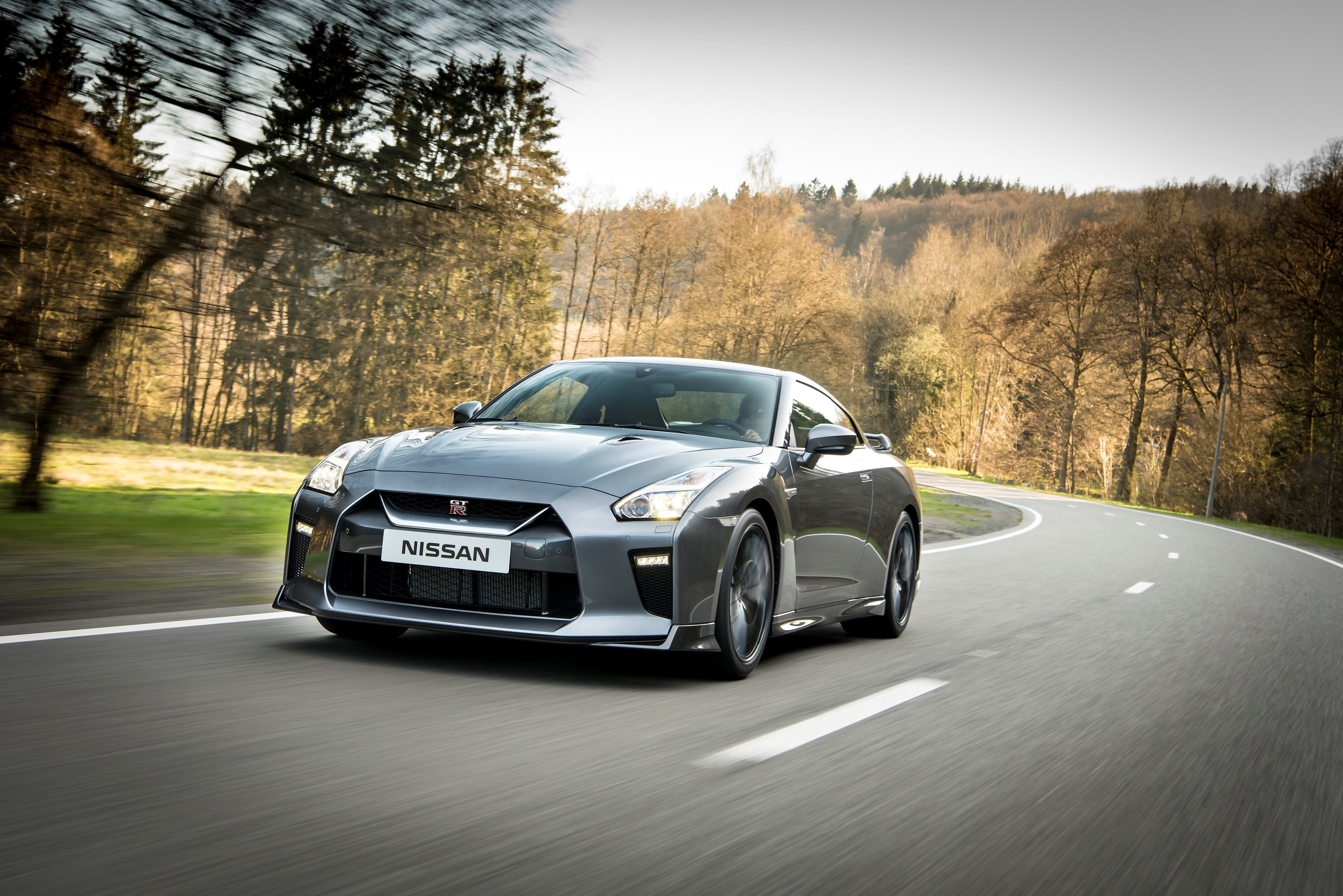 Nissan GT-R driving on a winding road HD Wallpaper