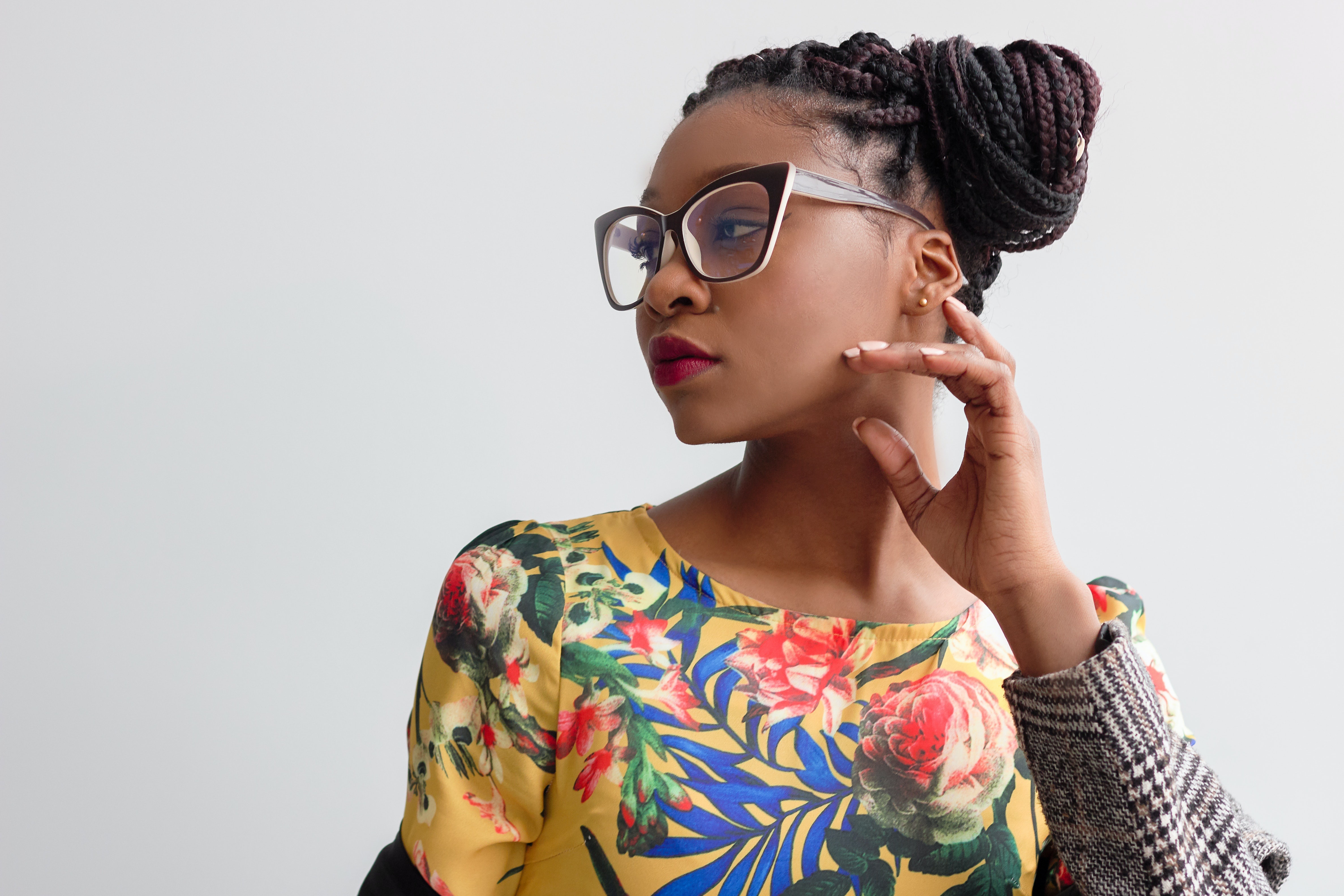 Woman with braided hair and glasses wearing a floral top HD Wallpaper