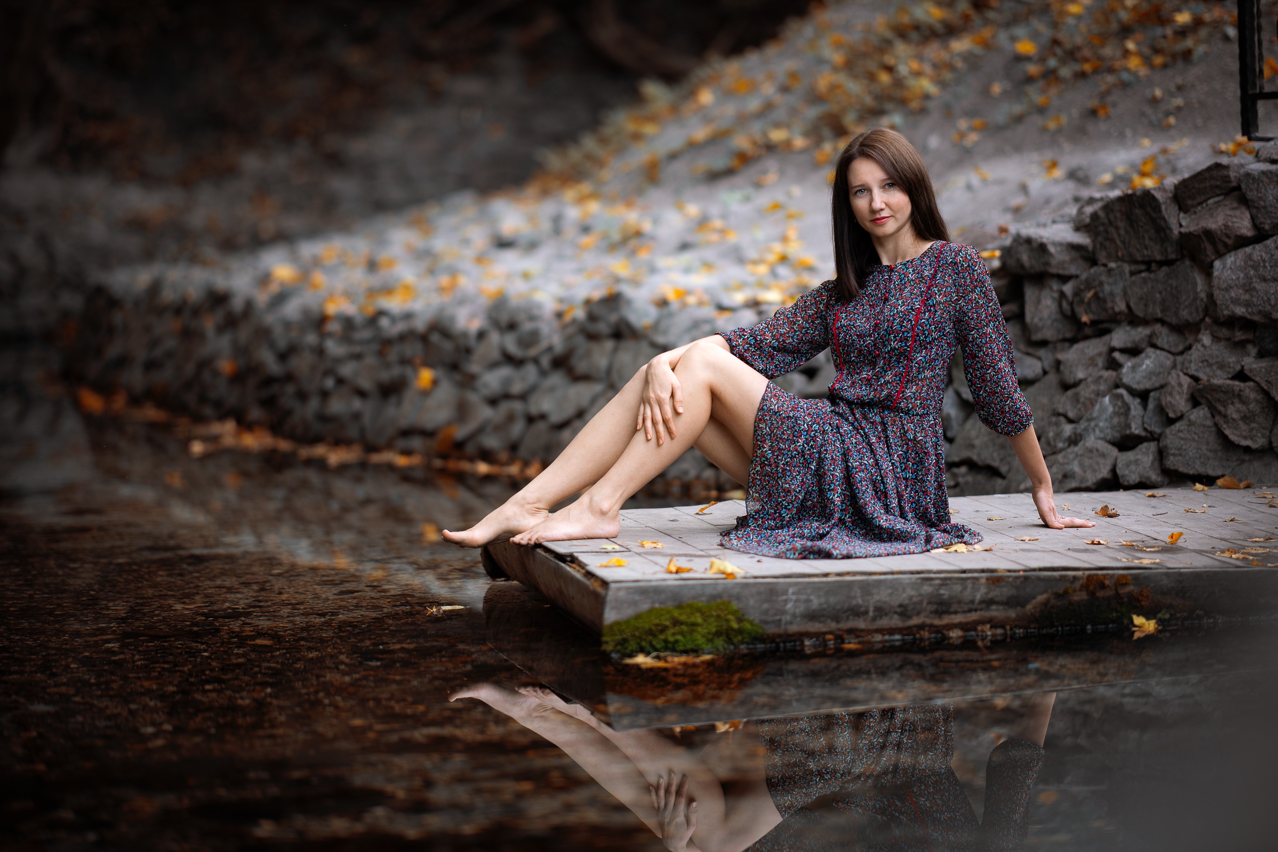 Woman in a floral dress sitting on a dock HD Wallpaper