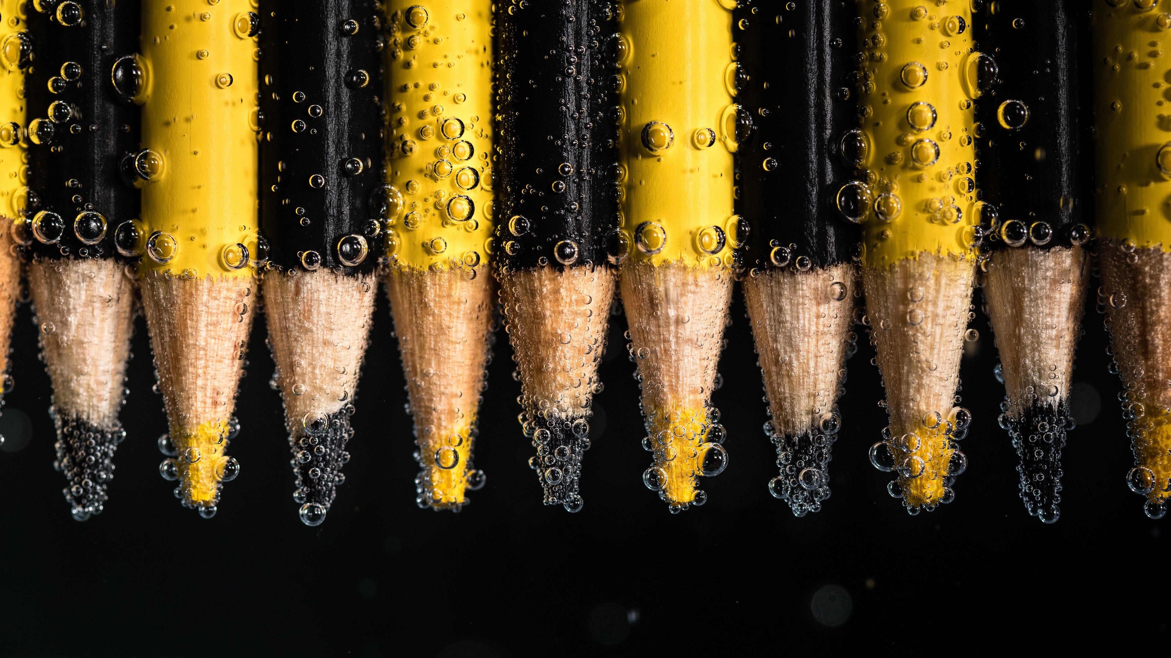 Macro photography of pencils in water with bubbles HD Wallpaper