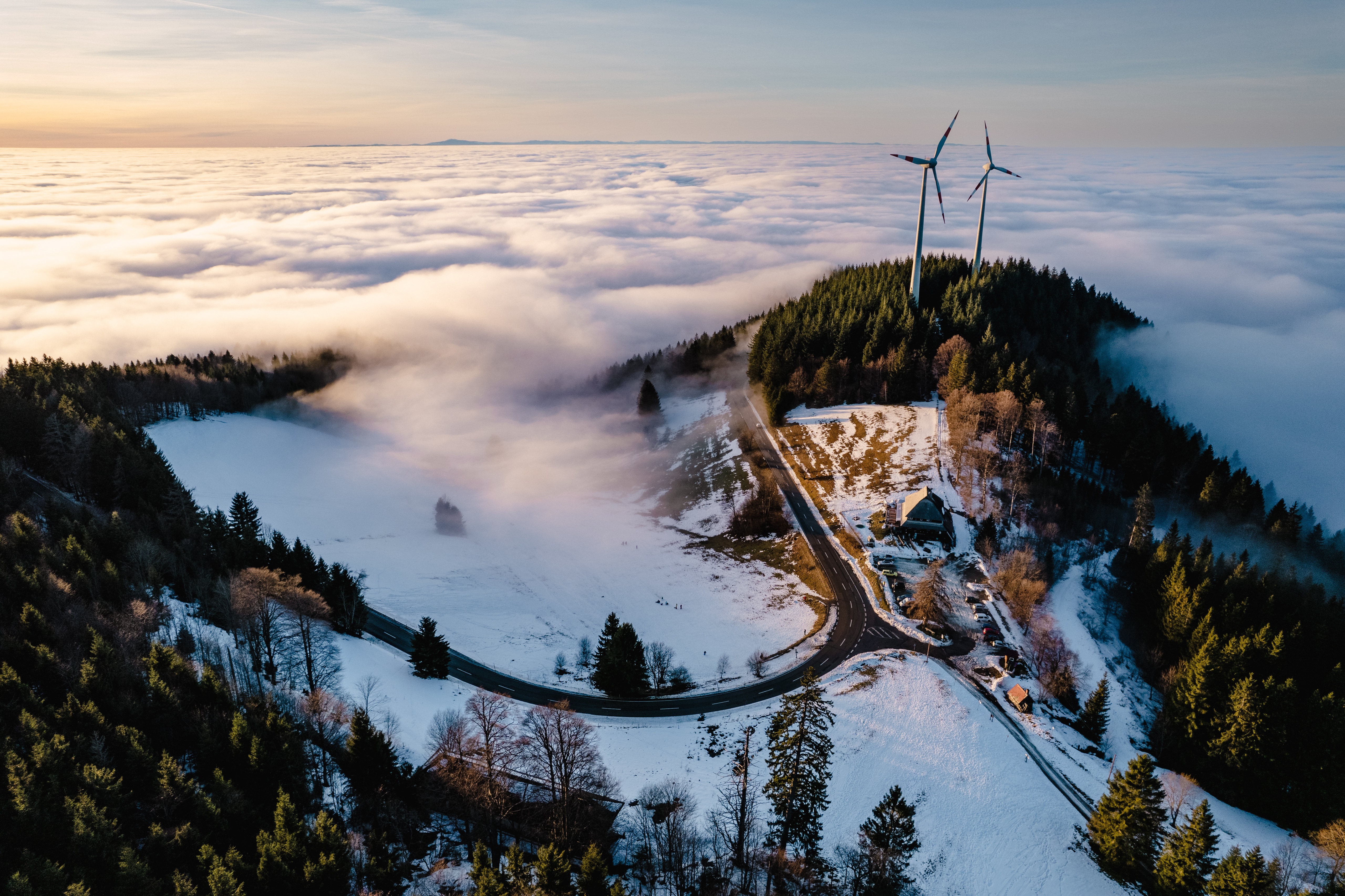 Wind turbines above sea of clouds at sunset HD Wallpaper