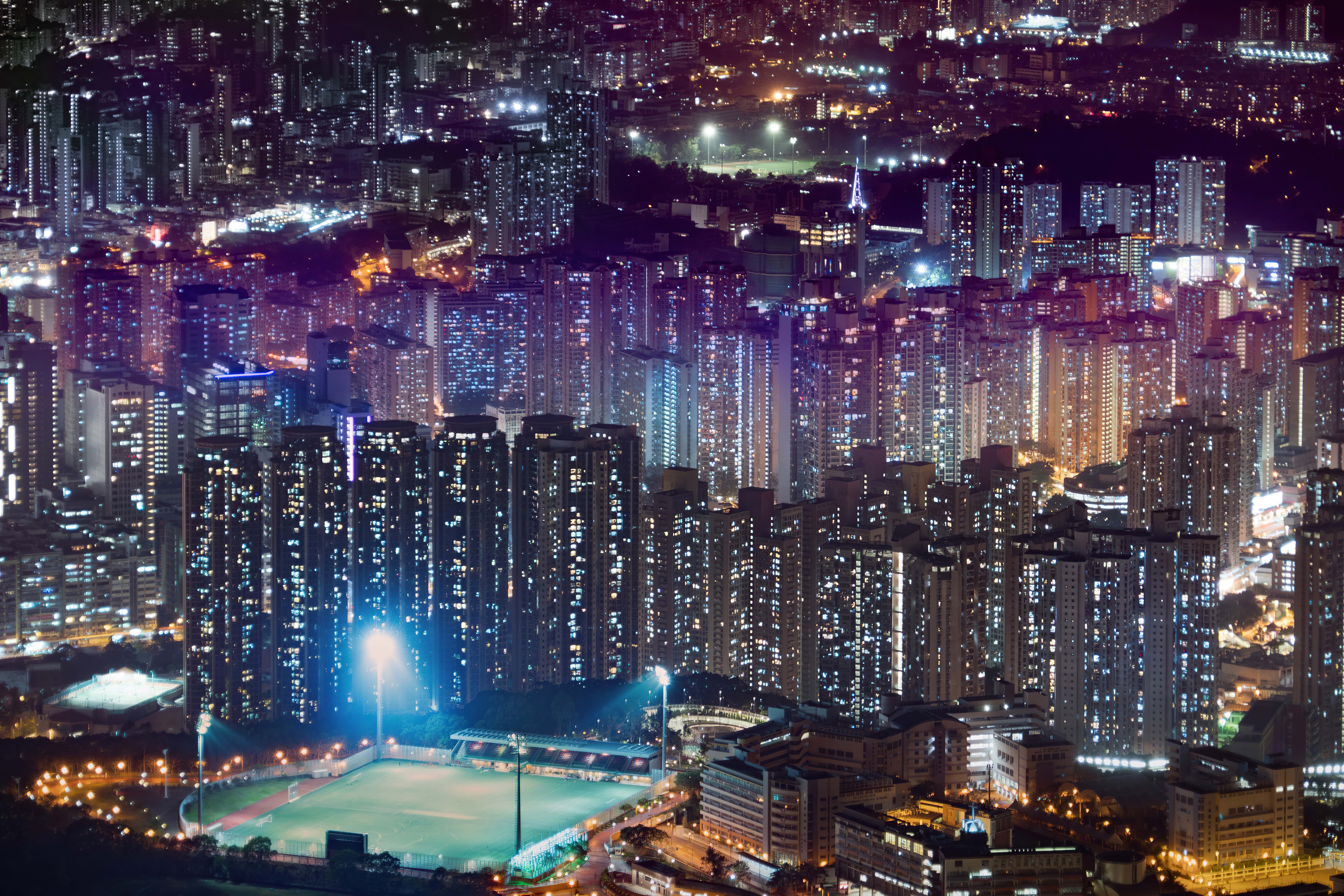 Hong Kong cityscape at night with illuminated skyscrapers HD Wallpaper