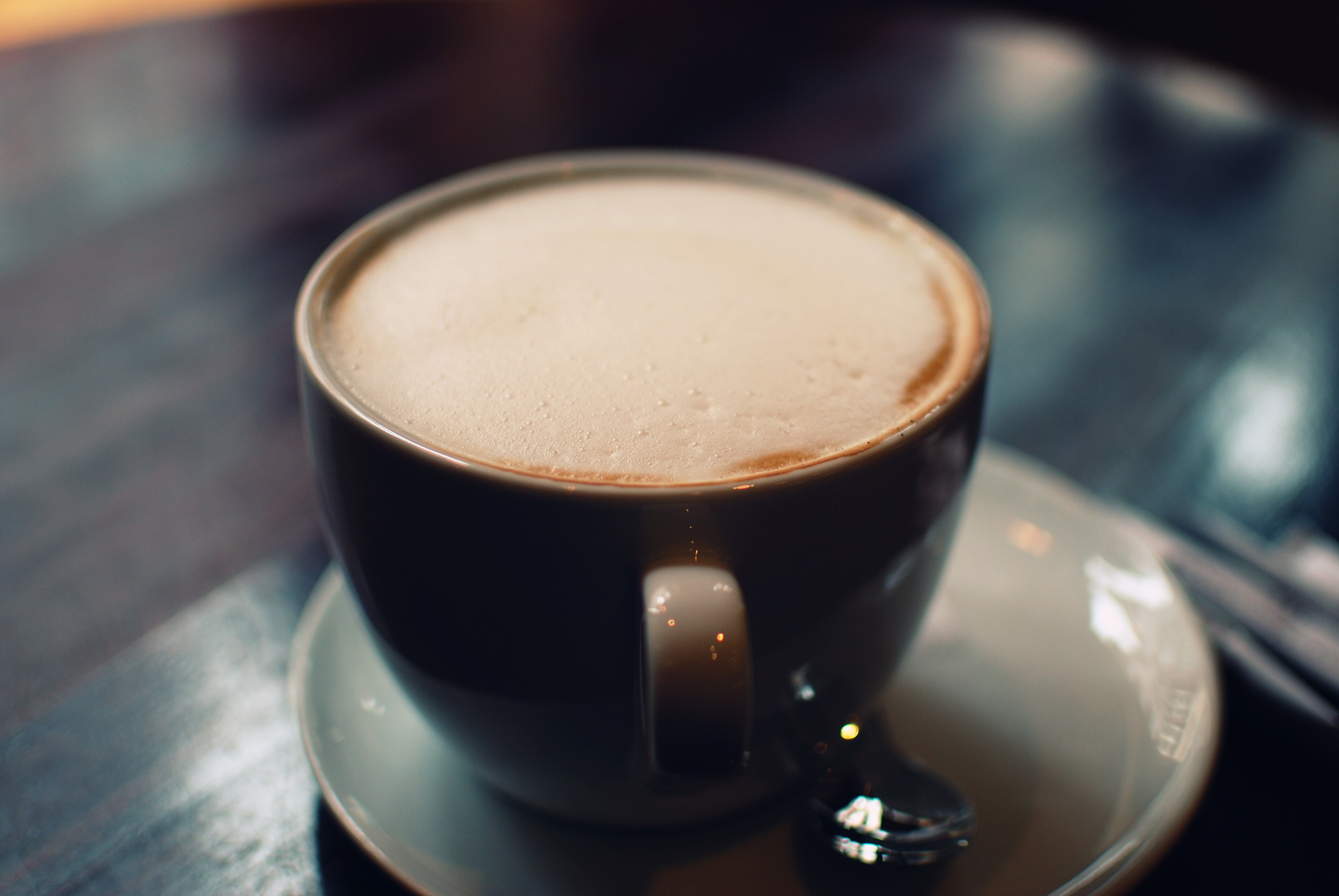 Cup of coffee with foam on a saucer HD Wallpaper