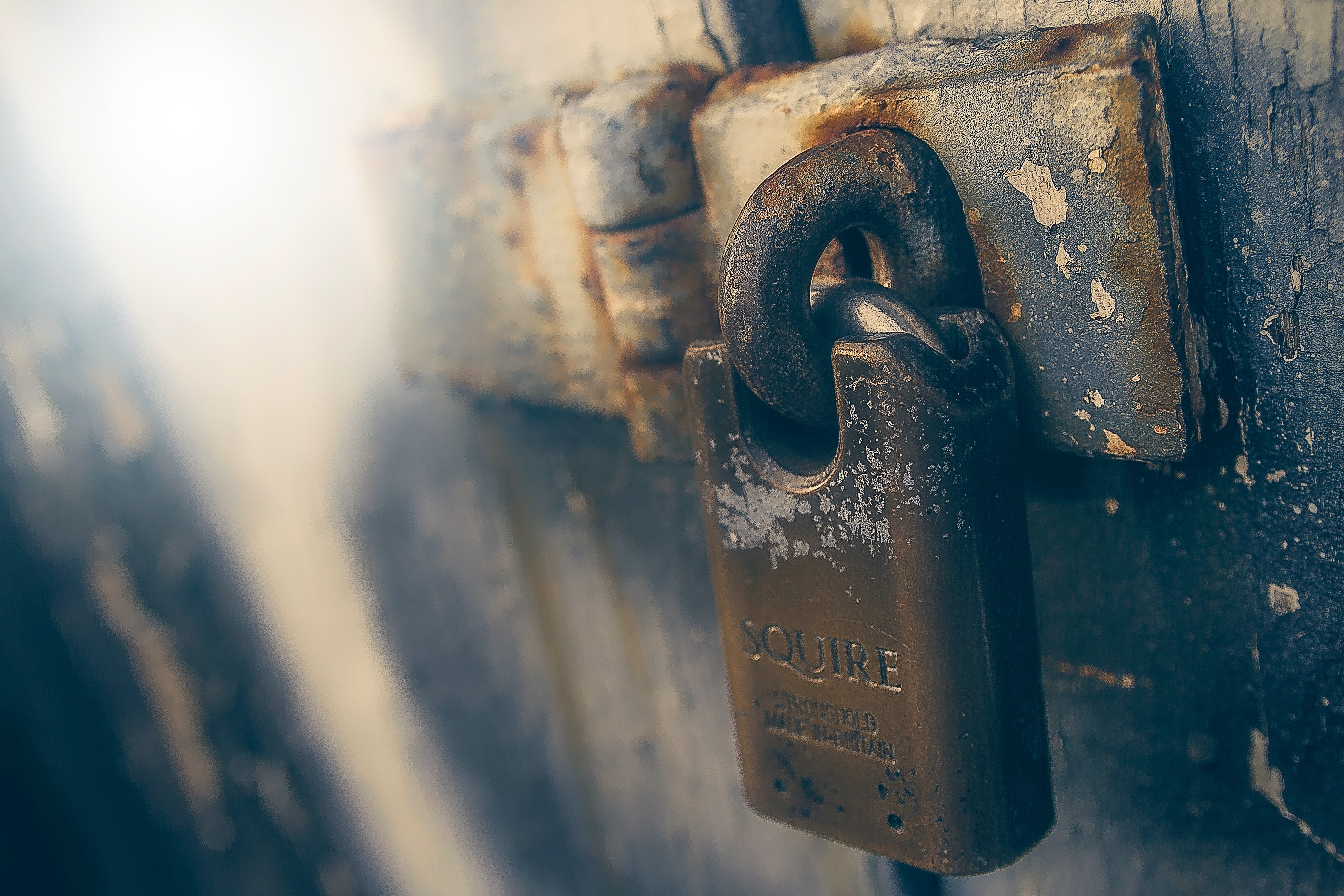Squire padlock on a rusty metal hasp HD Wallpaper