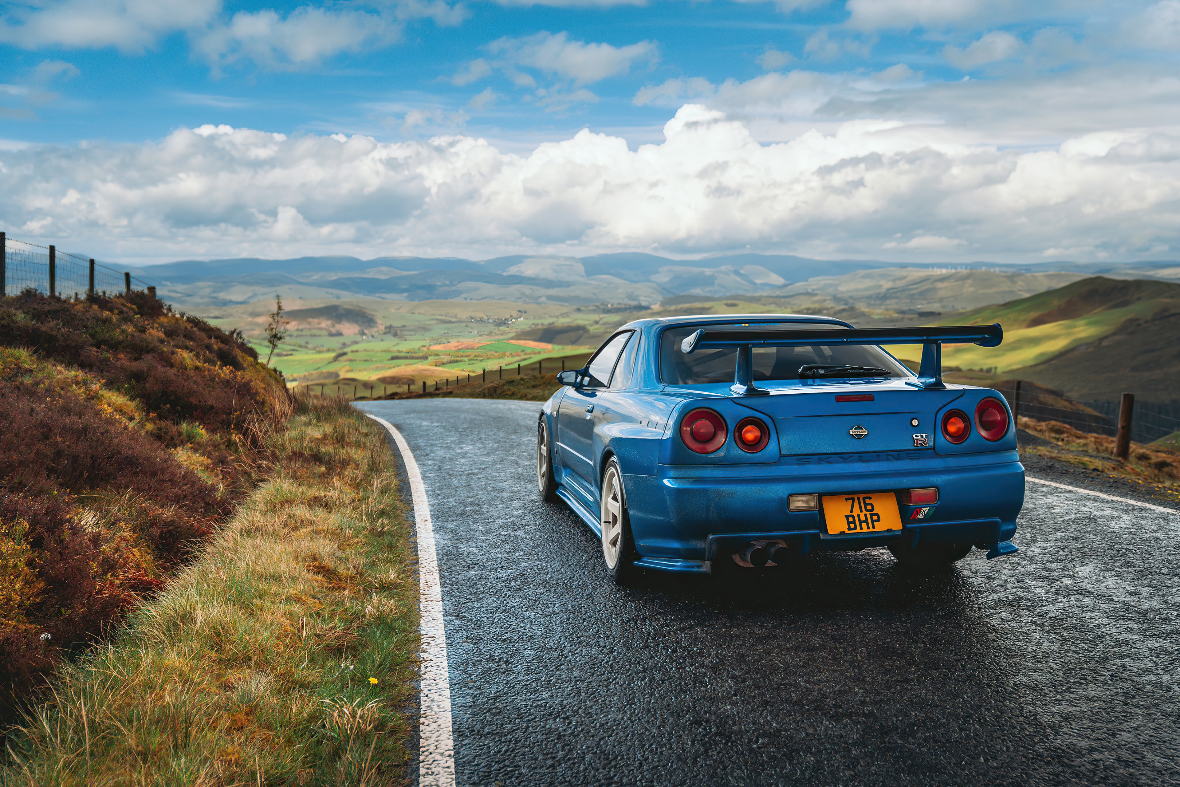 Blue Nissan Skyline R34 4K on a winding road HD Wallpaper