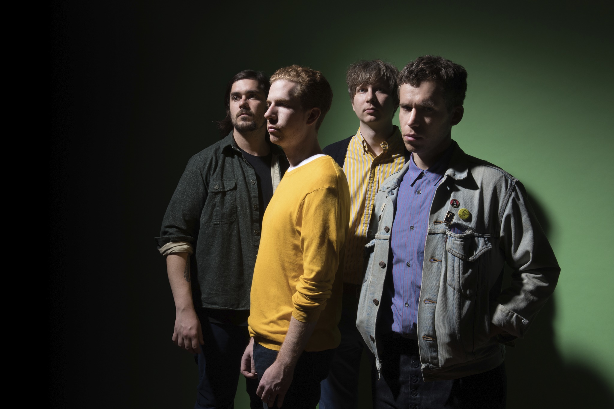 Parquet Courts band members posing against green background HD Wallpaper