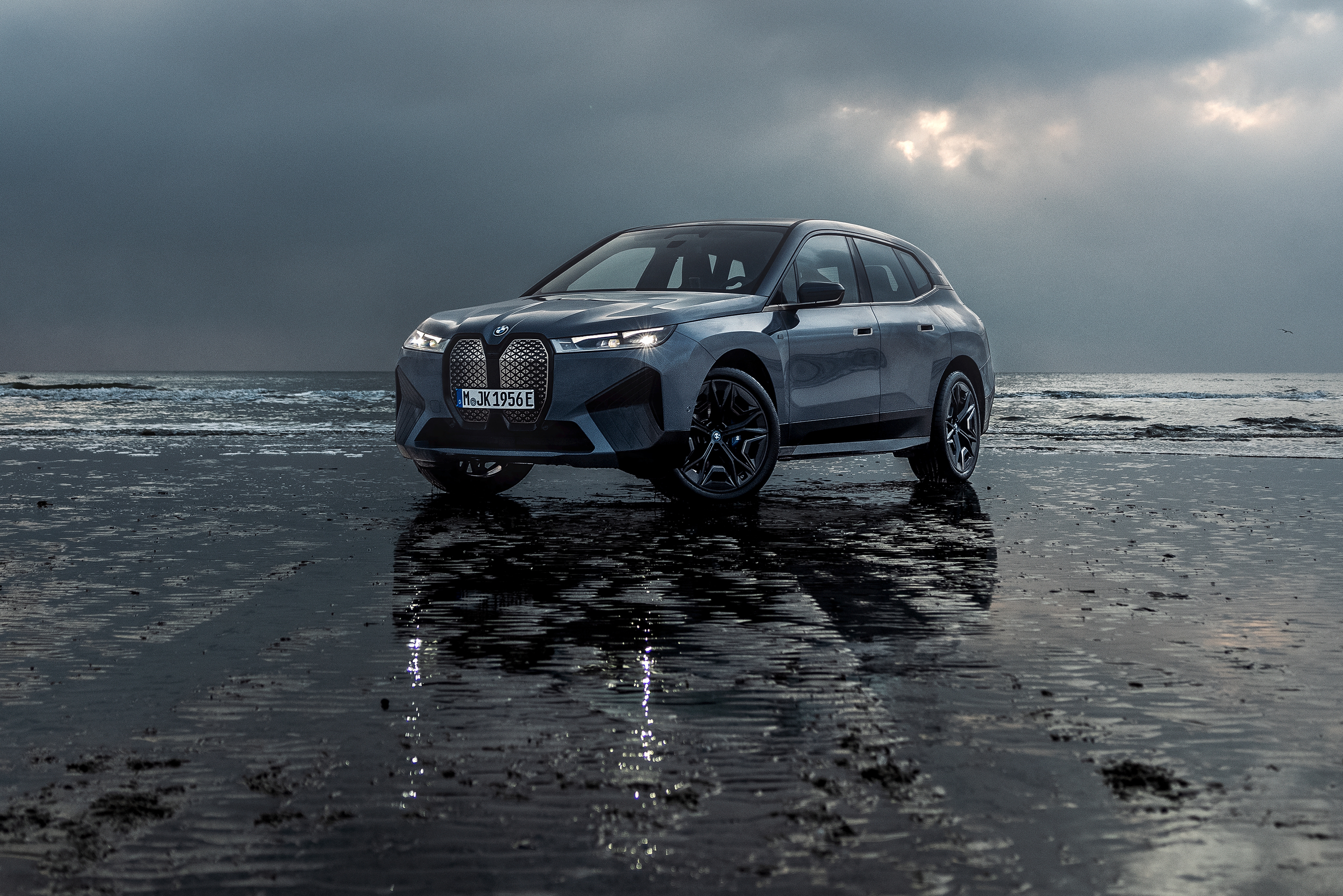 BMW iX M60 electric SUV on a beach HD Wallpaper