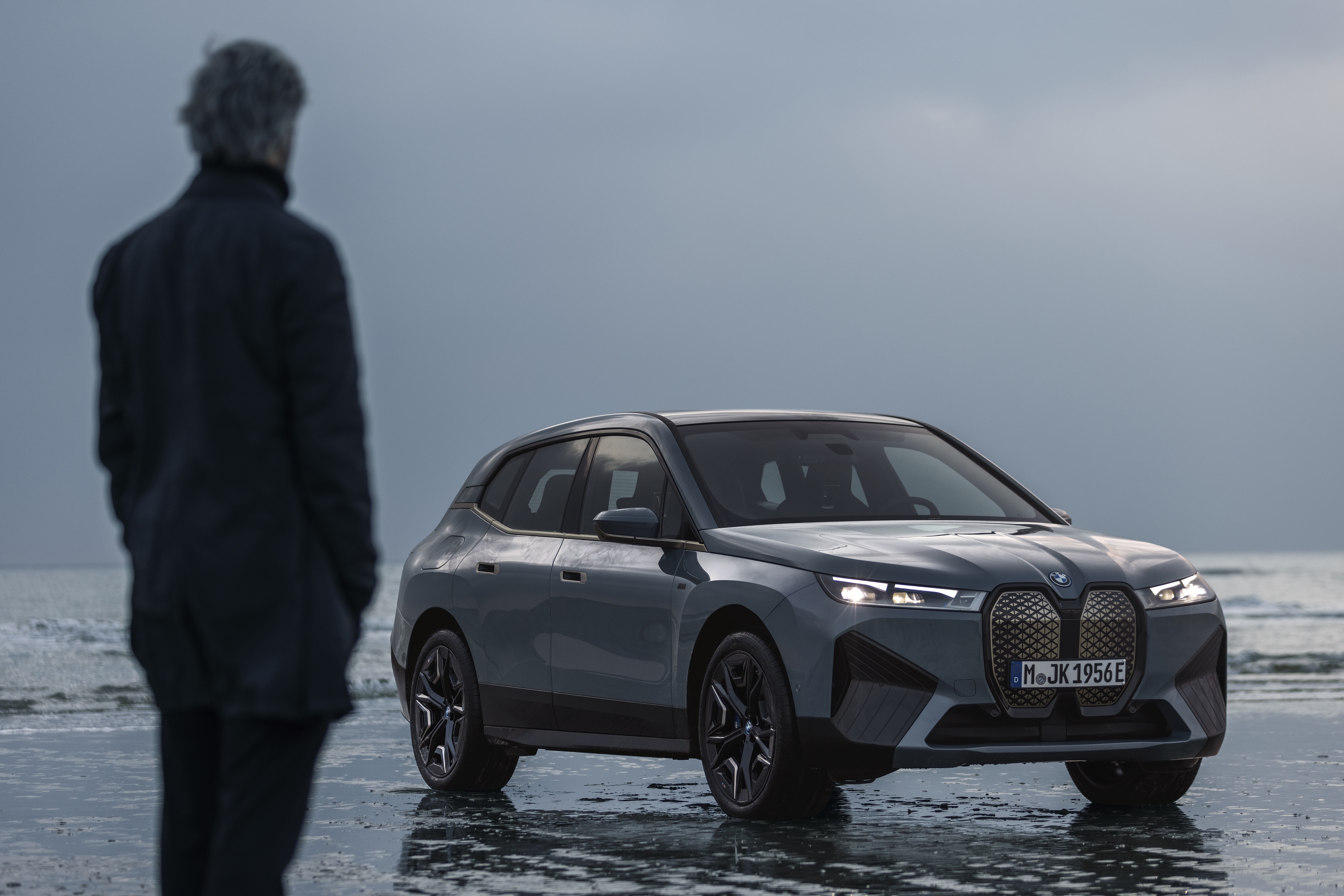 BMW iX M60 electric SUV on a beach HD Wallpaper