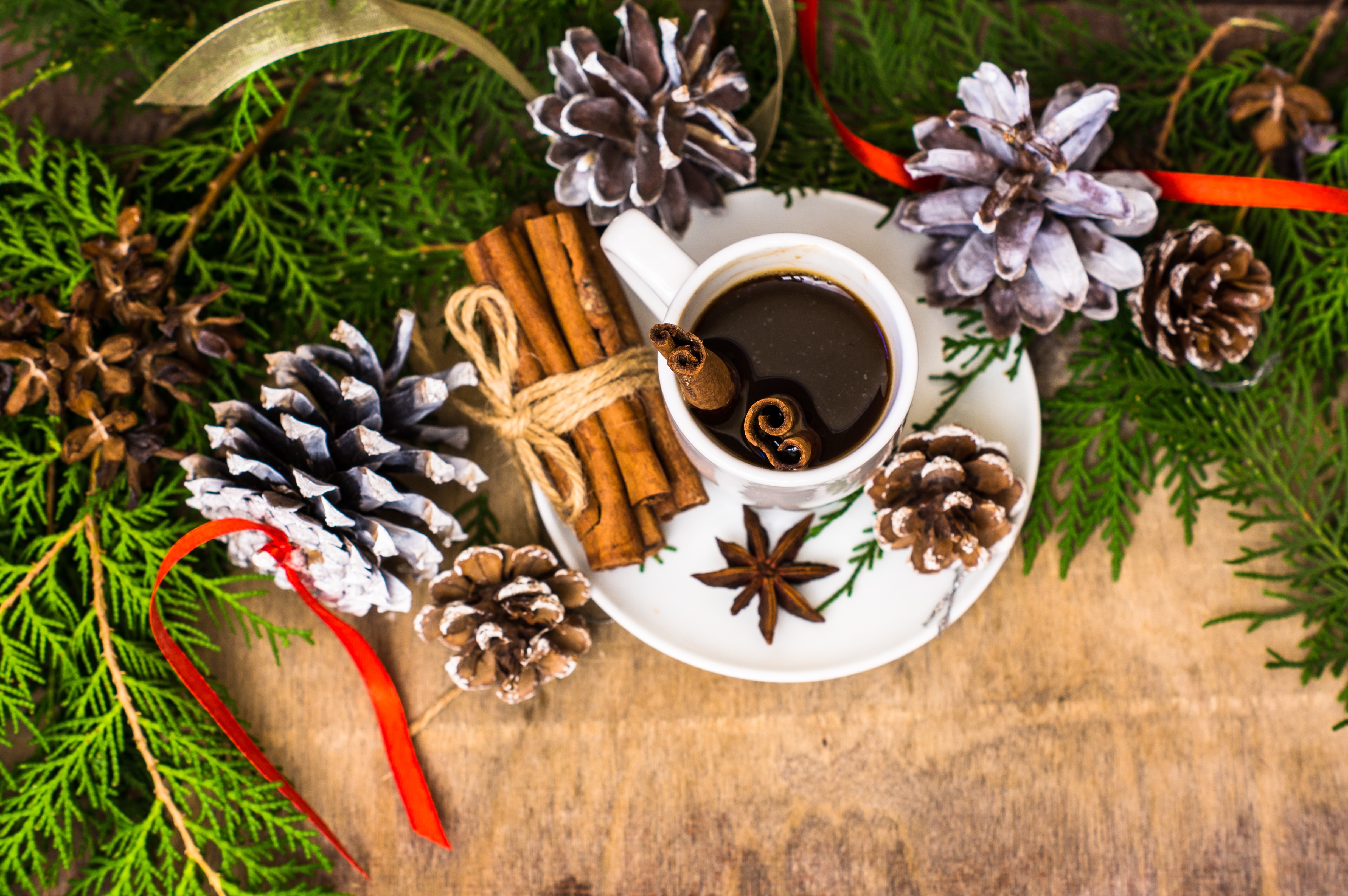 Coffee cup with cinnamon sticks and pine cones HD Wallpaper