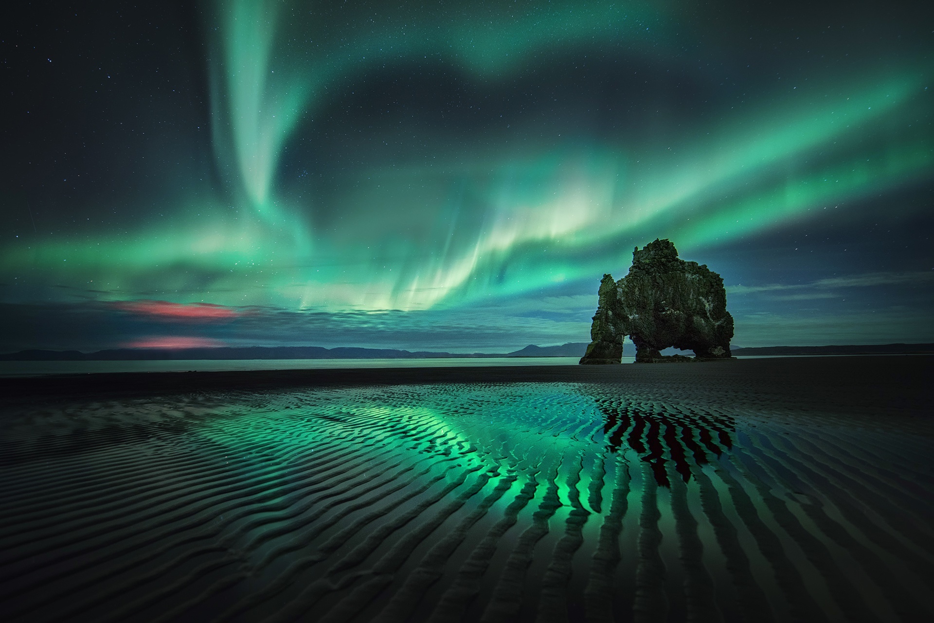 Aurora Borealis over Hvitserkur rock formation on beach HD Wallpaper