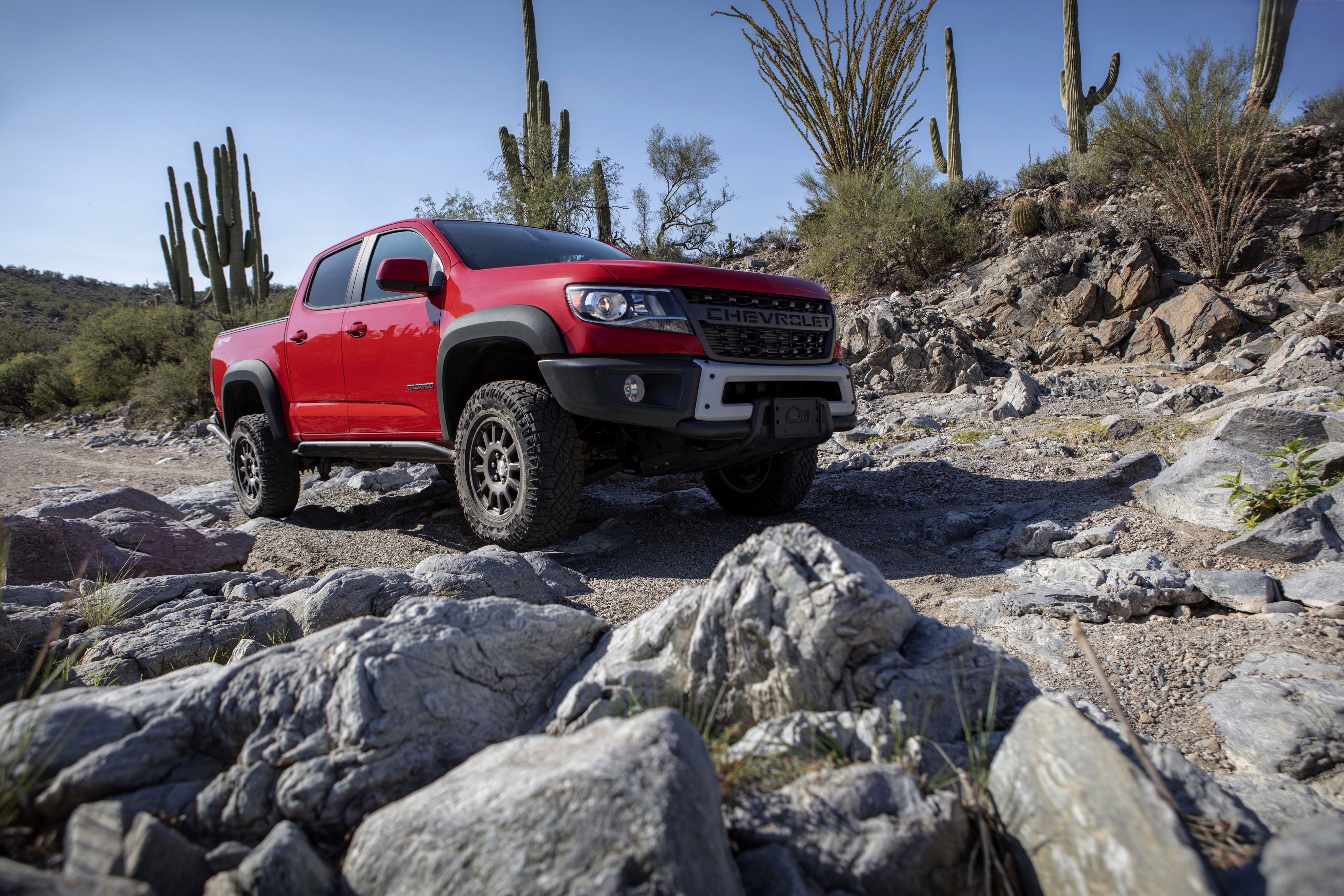 Red Chevrolet Colorado ZR2 in desert landscape HD Wallpaper