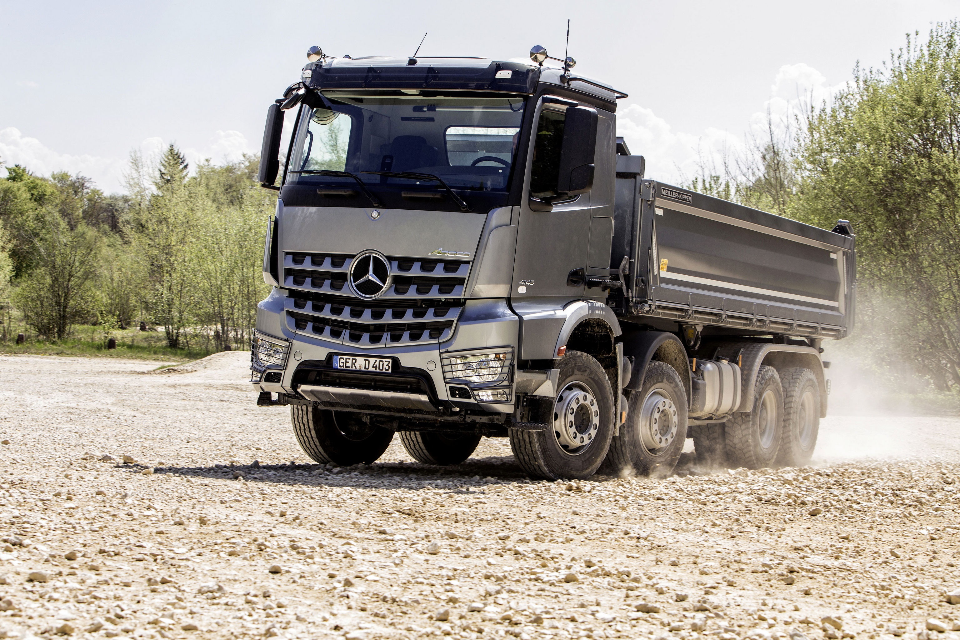 Mercedes-Benz Arocs dump truck driving on gravel HD Wallpaper