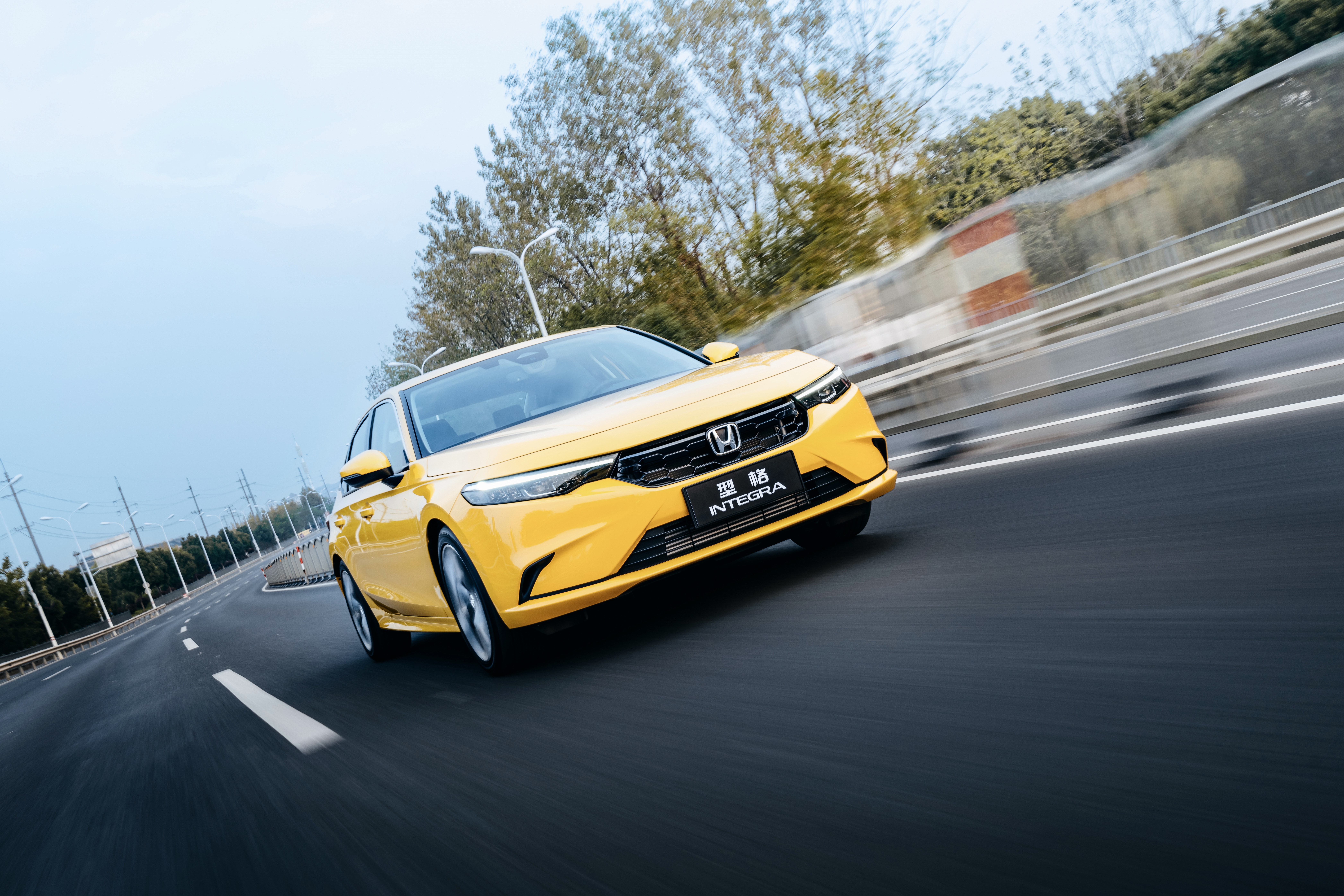 Yellow Honda Integra driving on a highway HD Wallpaper