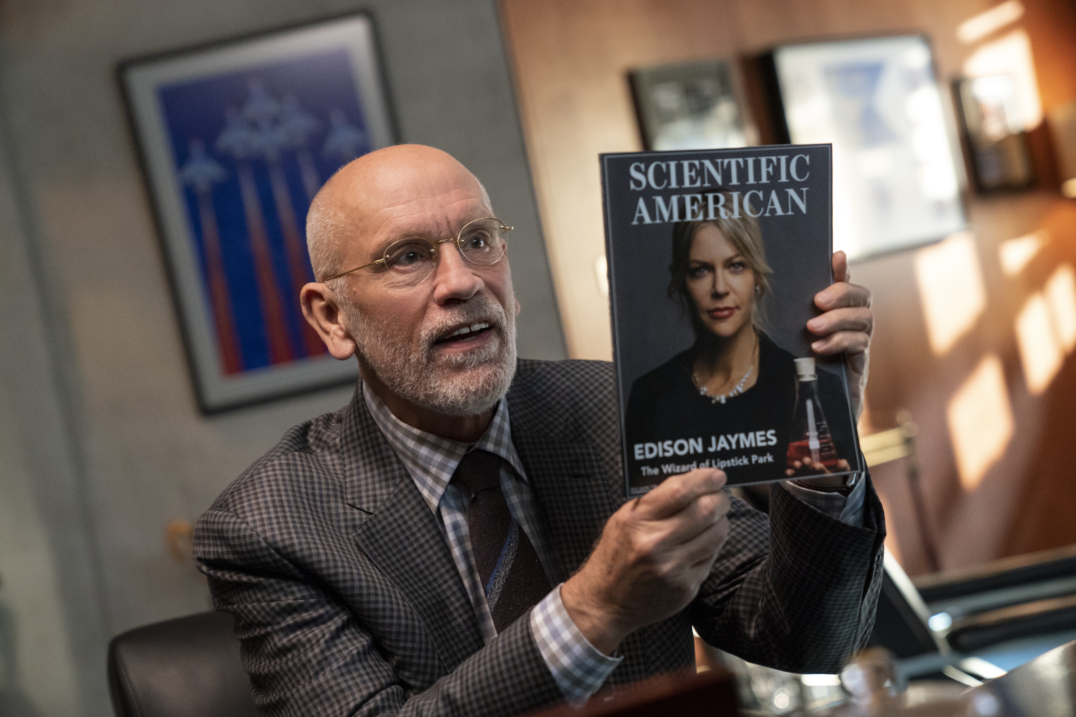 John Malkovich as Adrian Mallory holding Scientific American HD Wallpaper