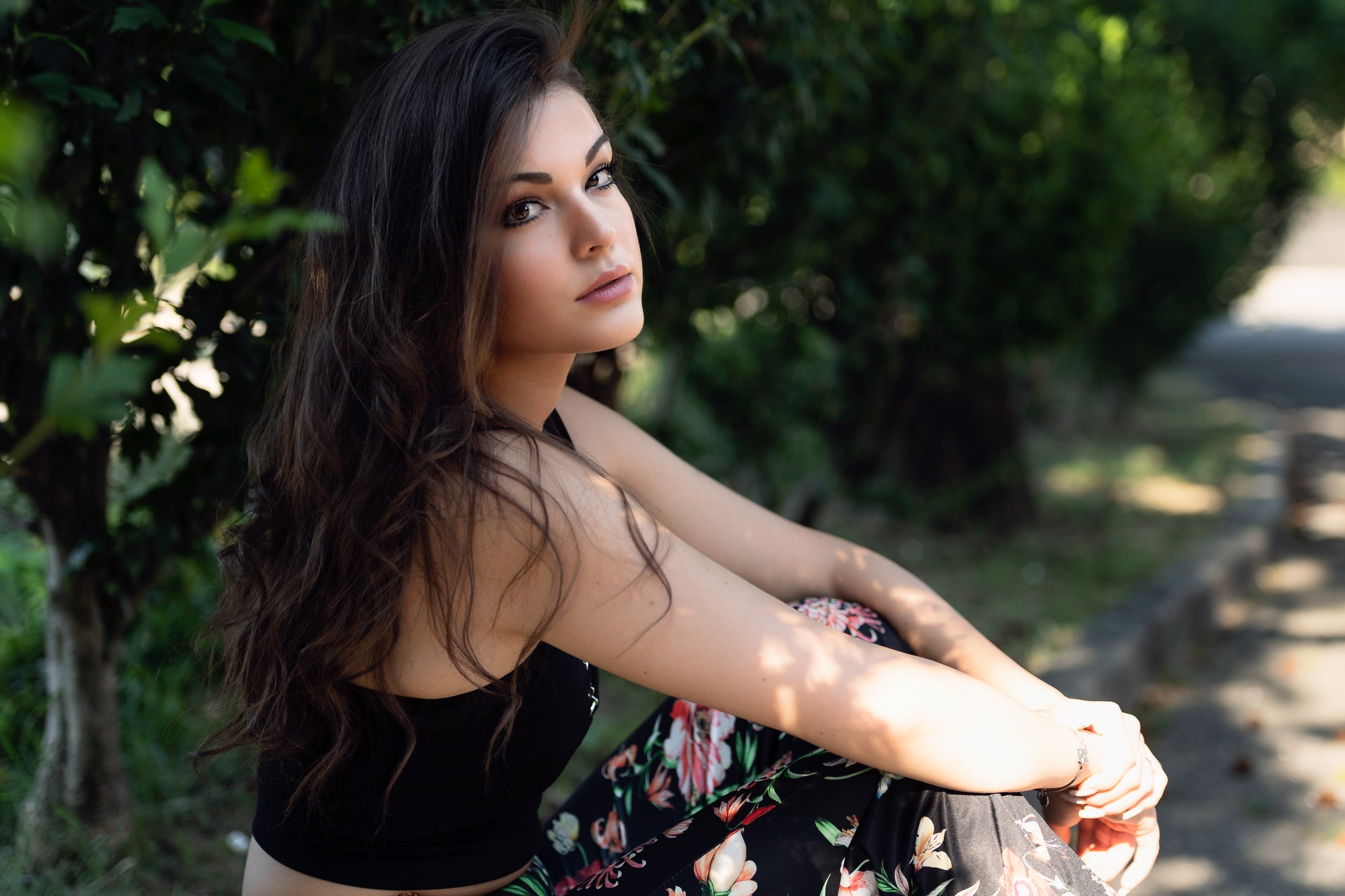 Brunette woman sitting outdoors HD Wallpaper