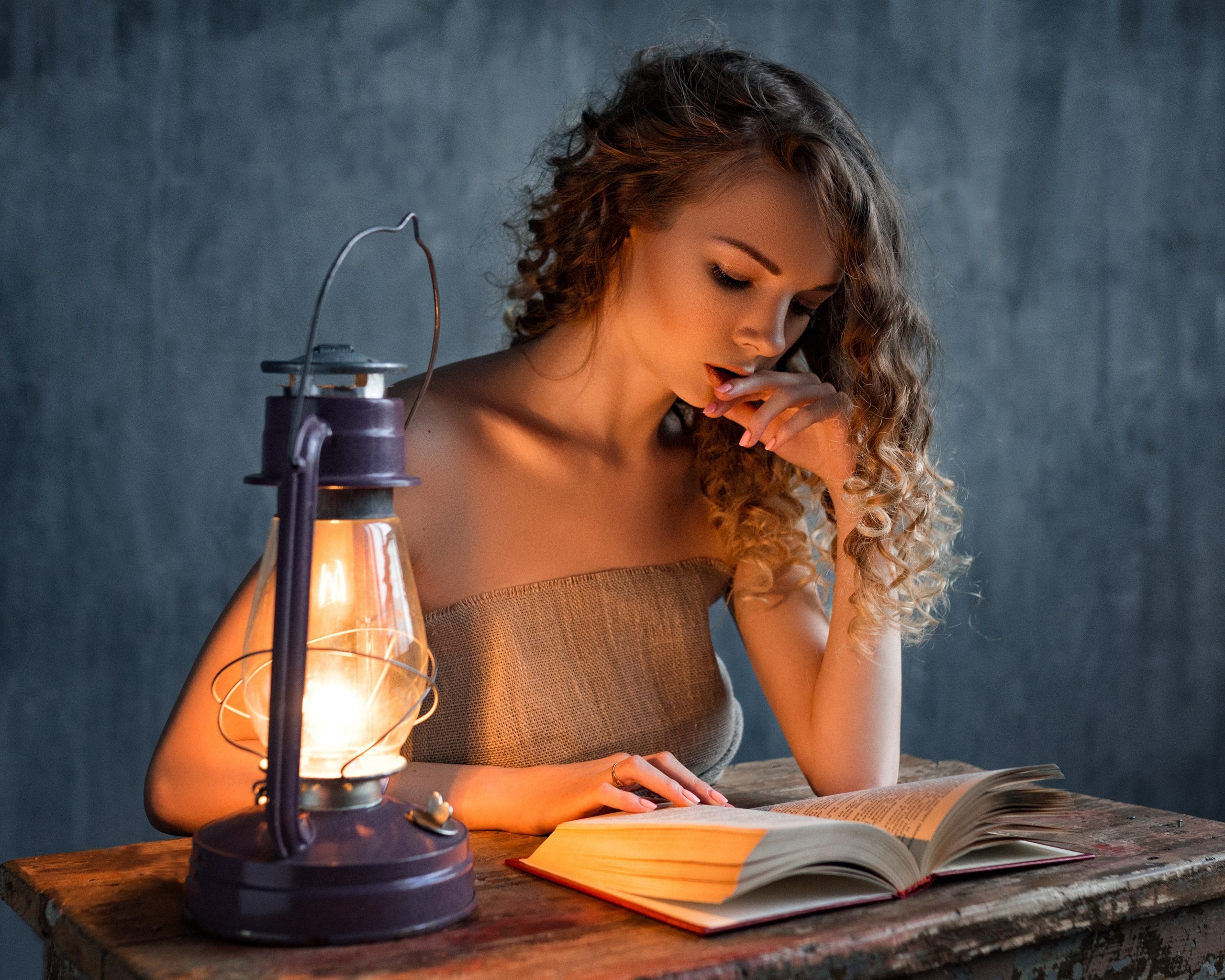 Woman reading by lantern light HD Wallpaper