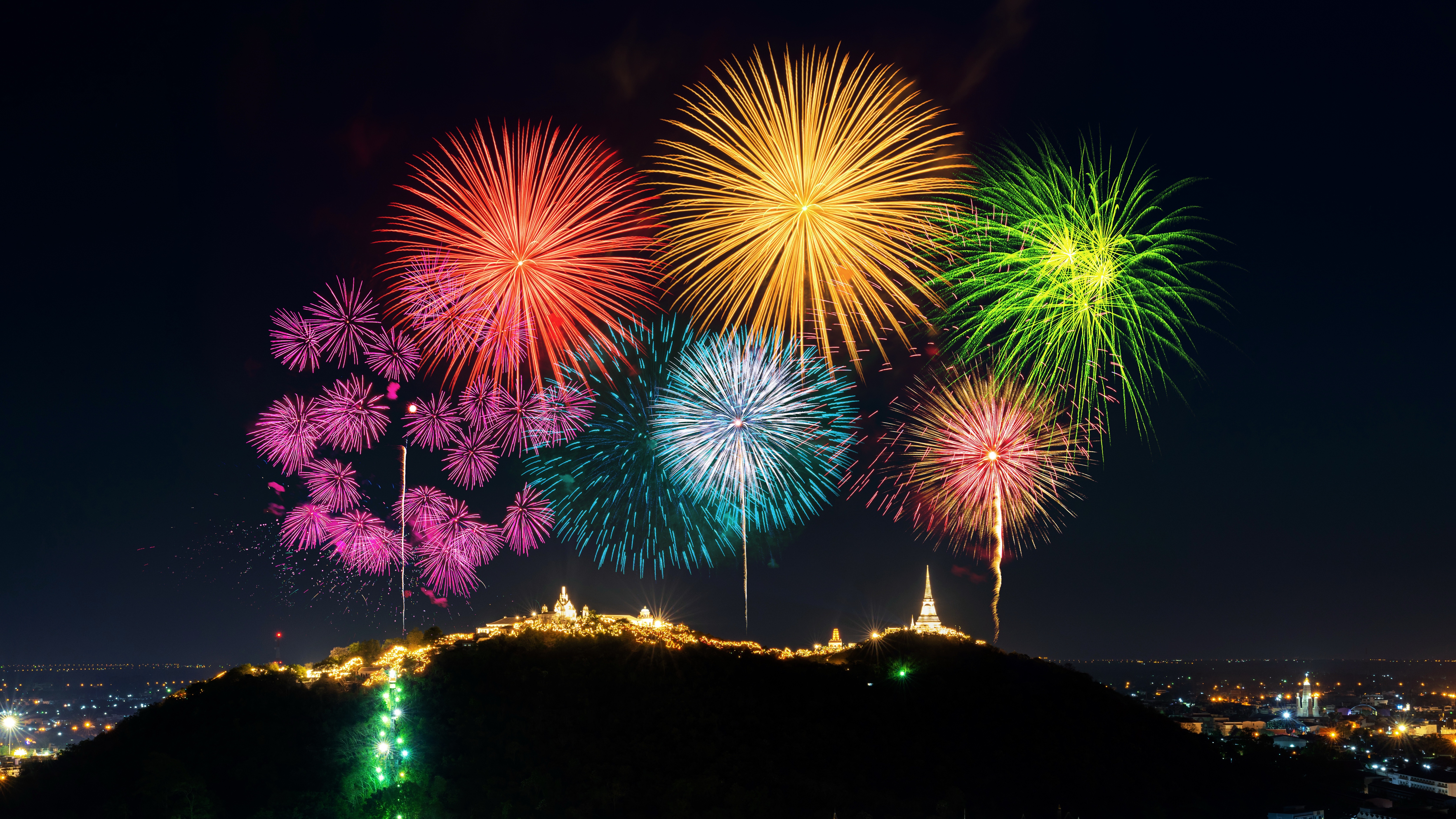 Fireworks over a hill at night HD Wallpaper