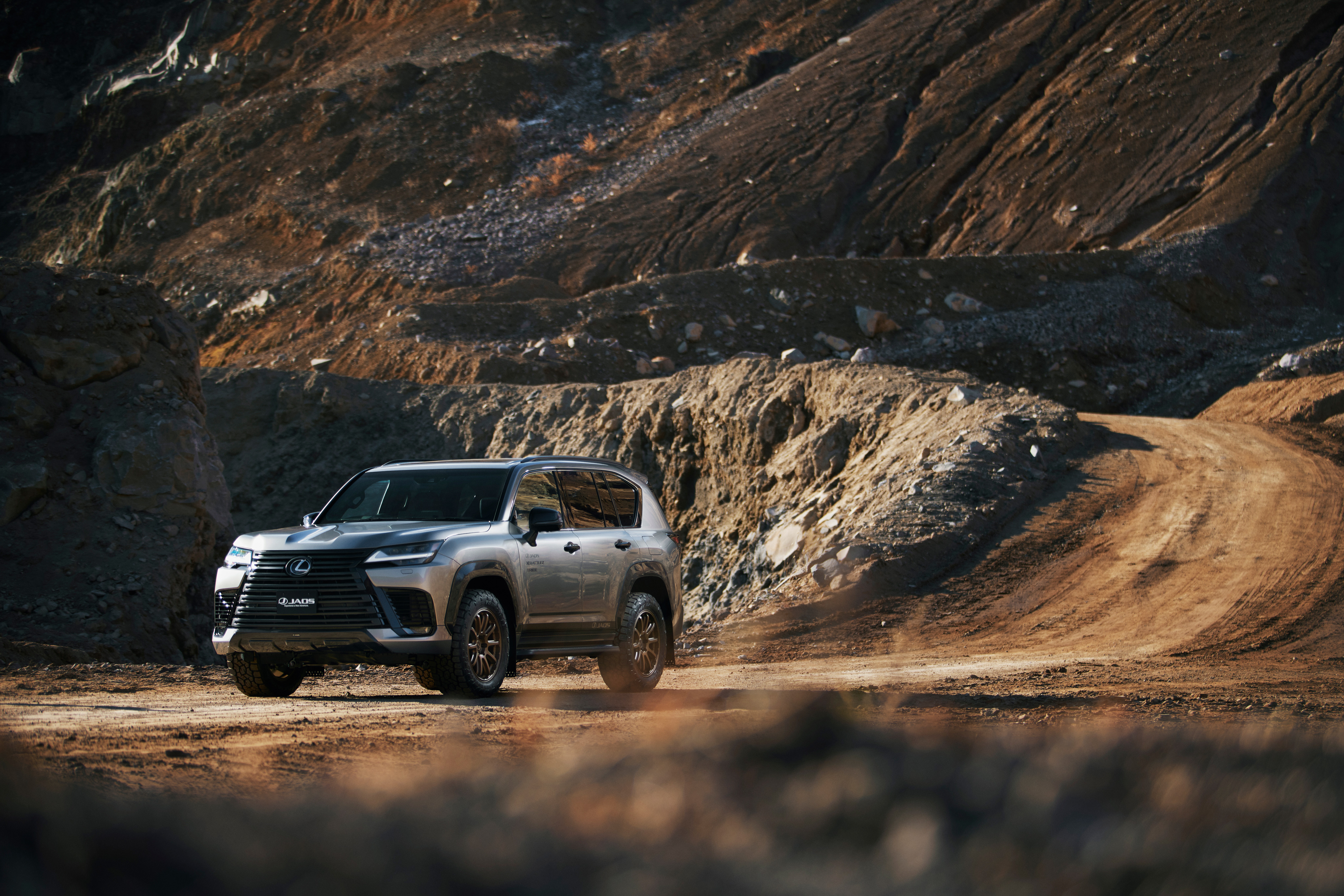 Lexus LX 600 SUV on a dirt road HD Wallpaper
