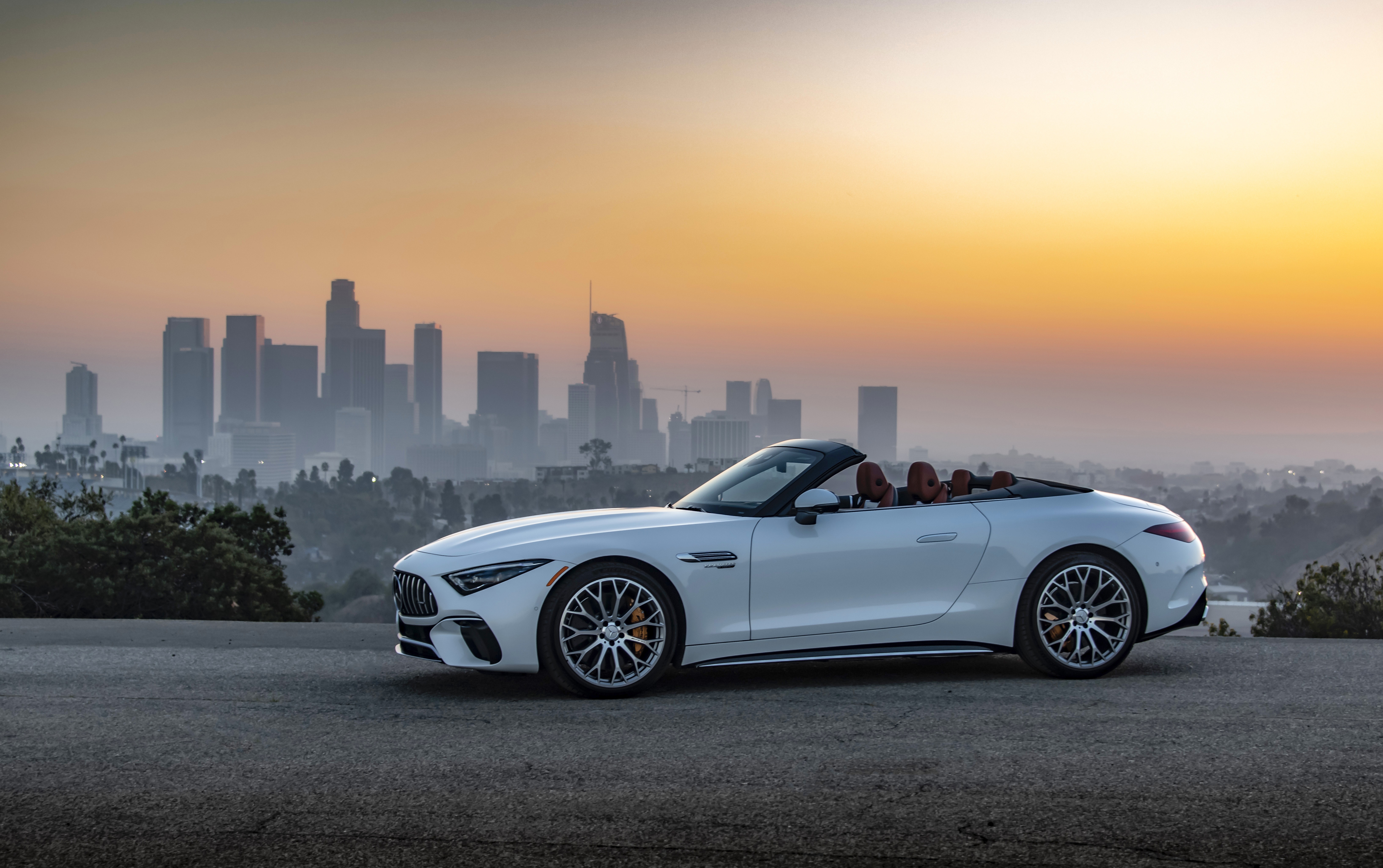 White Mercedes-AMG SL Cabriolet in front of Los Angeles skyline HD Wallpaper
