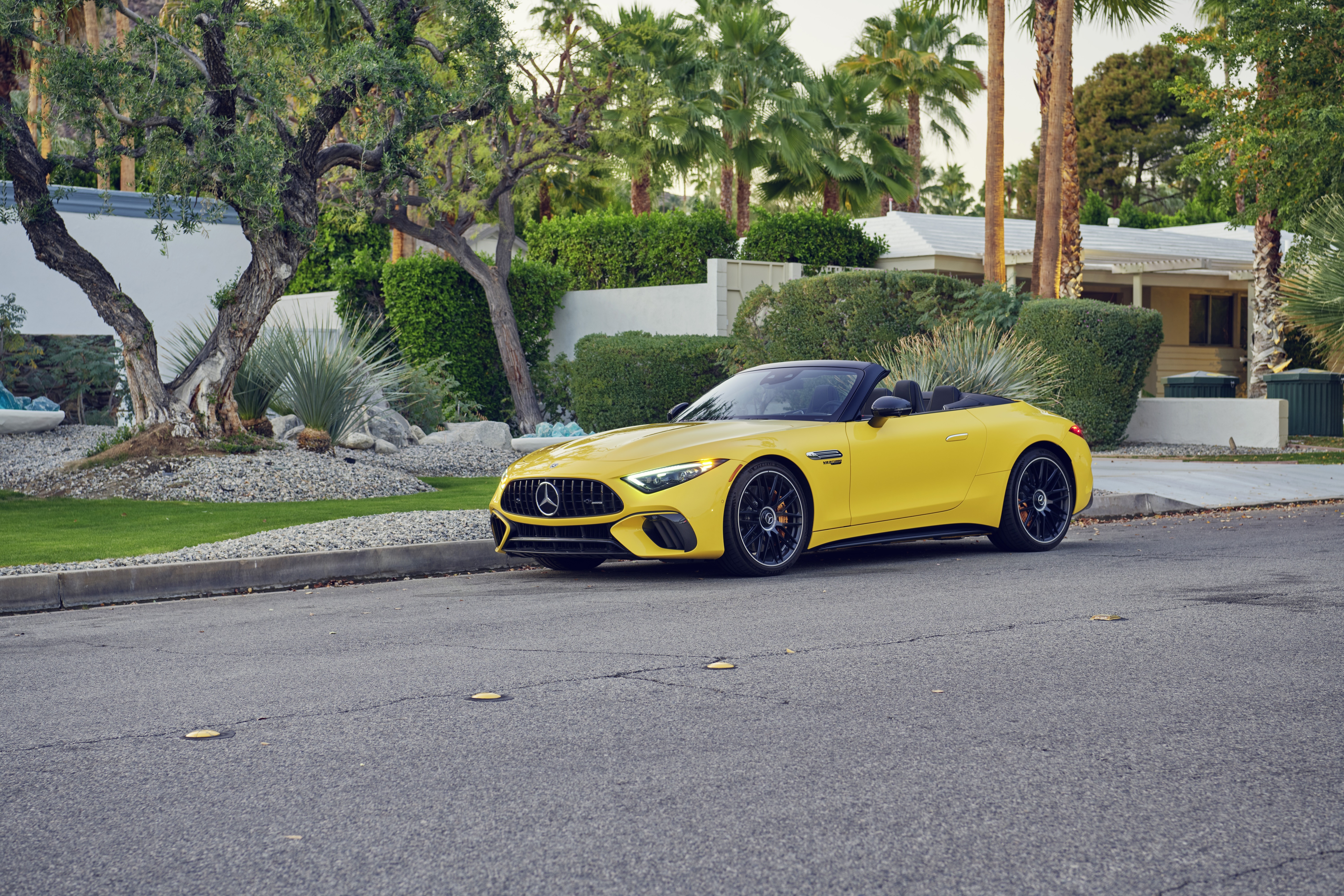 Yellow Mercedes-AMG SL Cabriolet parked on street HD Wallpaper