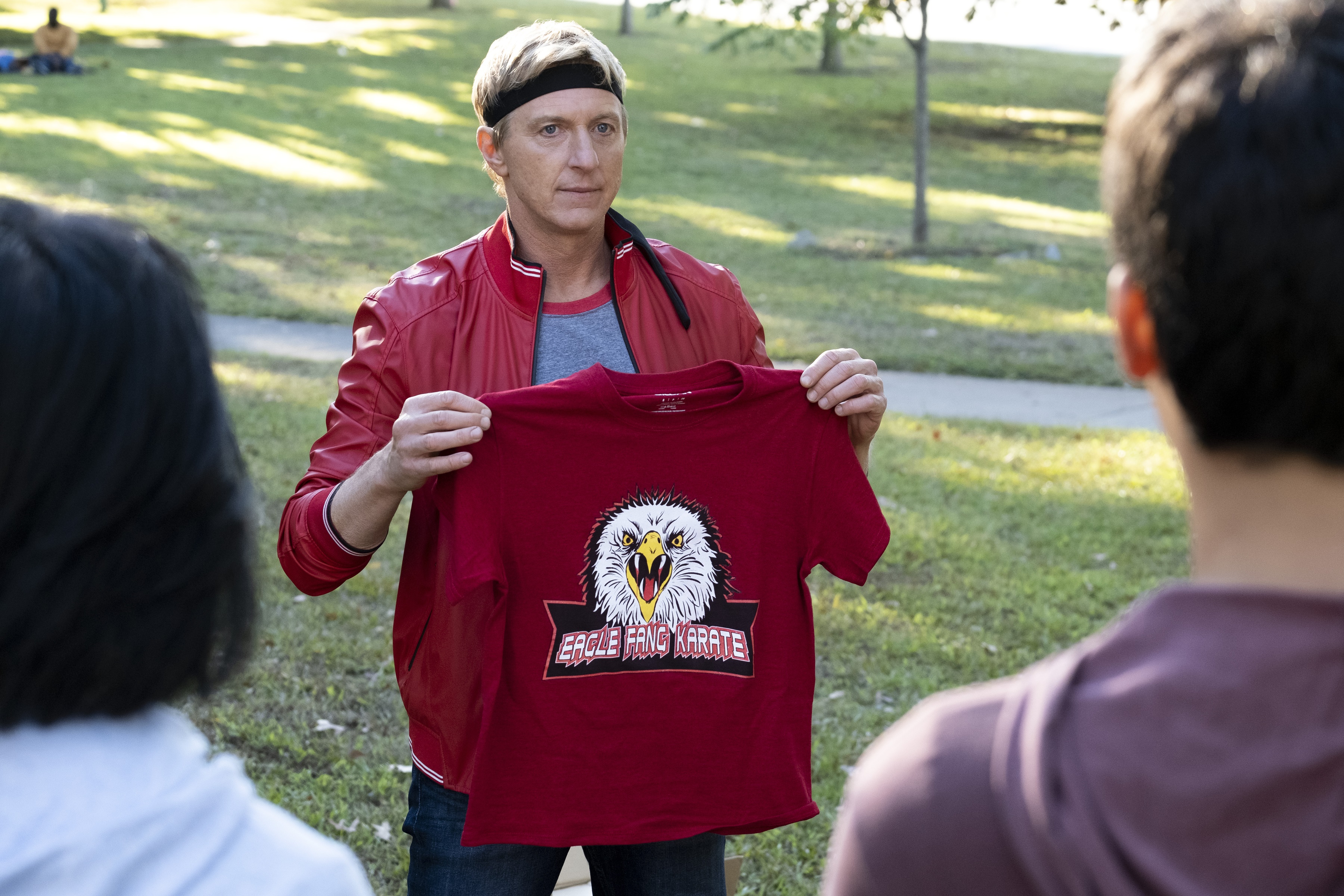 Johnny Lawrence from Cobra Kai holding an Eagle Fang Karate t-shirt HD Wallpaper
