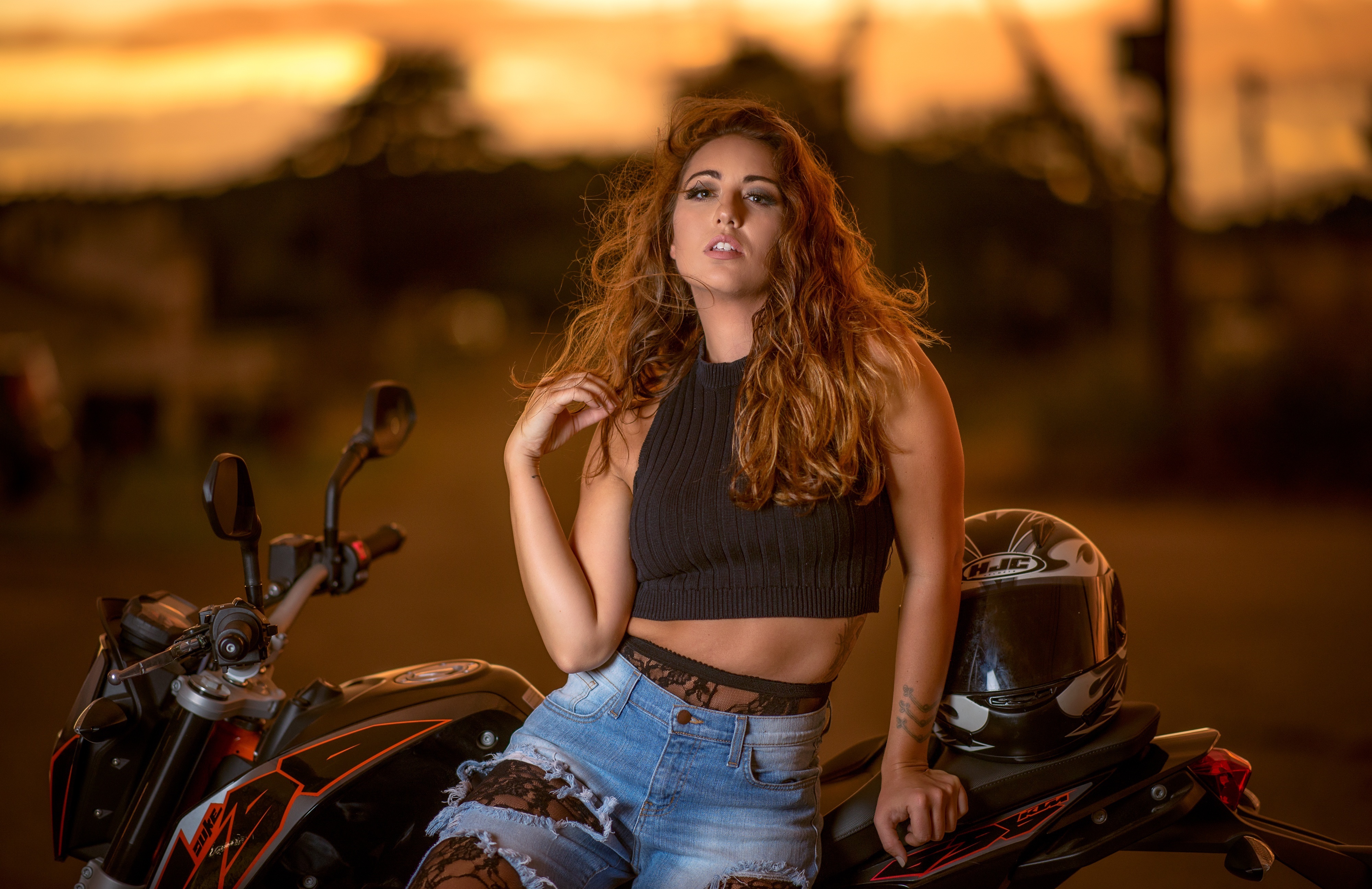 Woman with Red Hair Poses on a Motorcycle HD Wallpaper