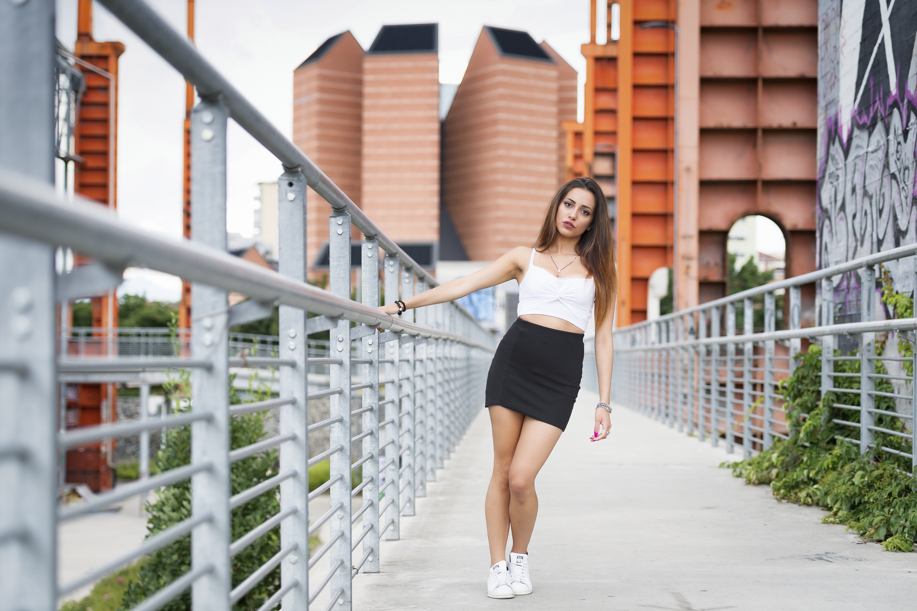 Woman in skirt on bridge with graffiti HD Wallpaper