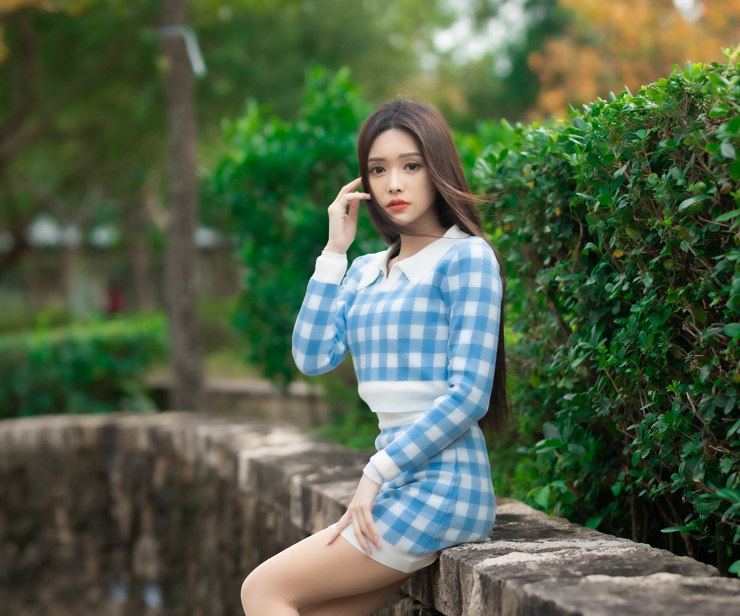 Asian woman with long brown hair in blue plaid outfit HD Wallpaper