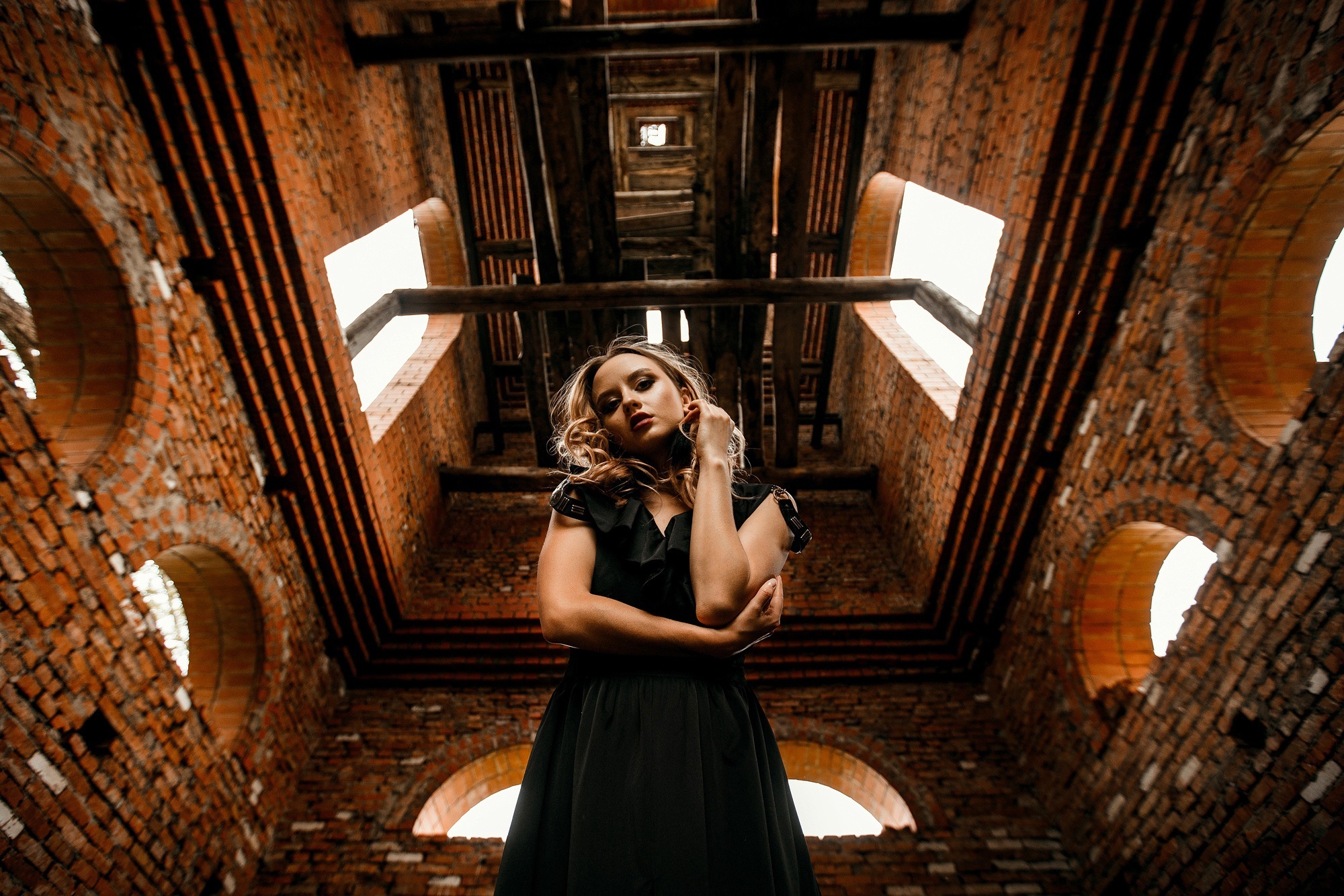 Woman in black dress in brick building HD Wallpaper