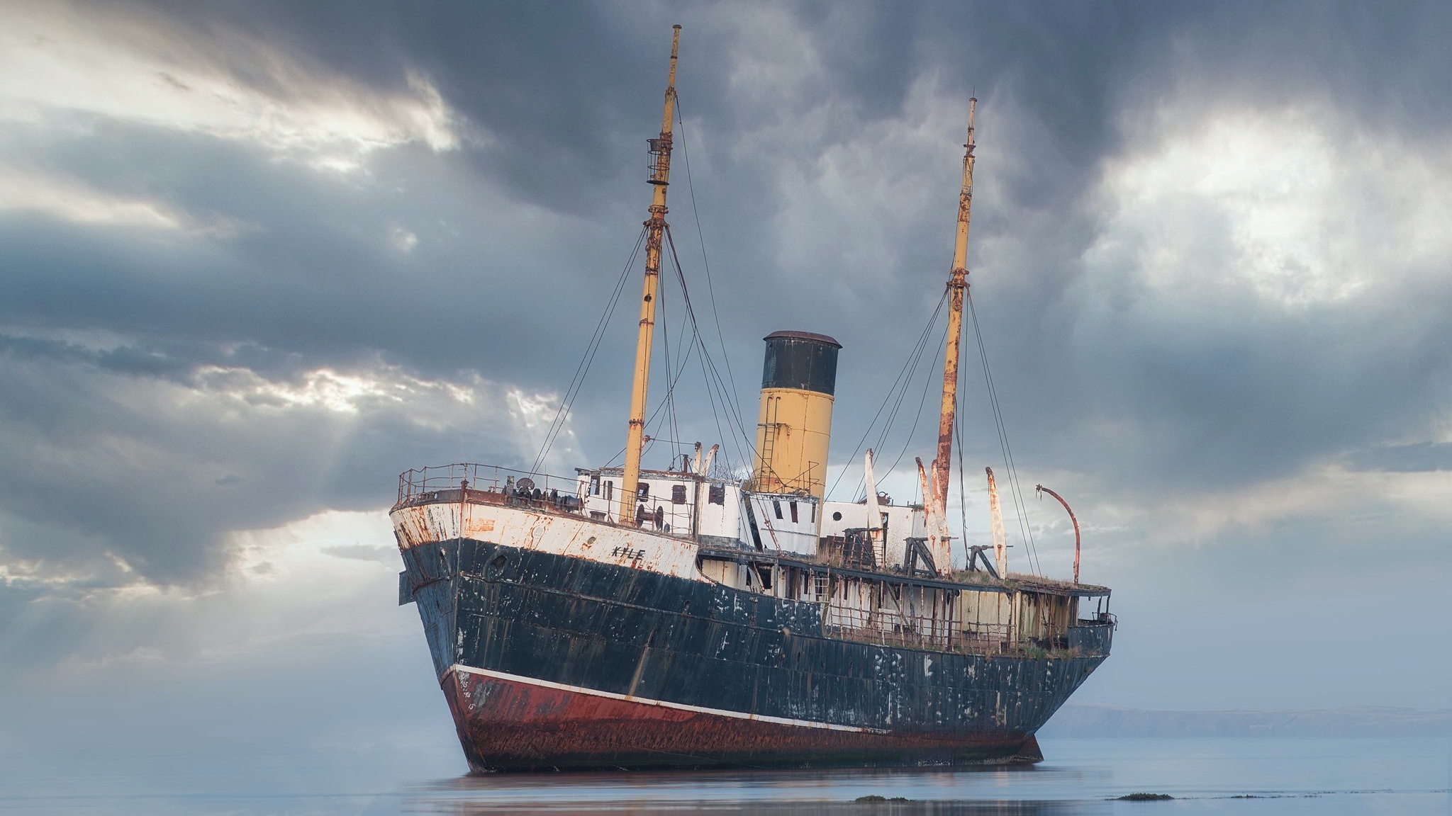 Abandoned ship on the water under cloudy sky HD Wallpaper