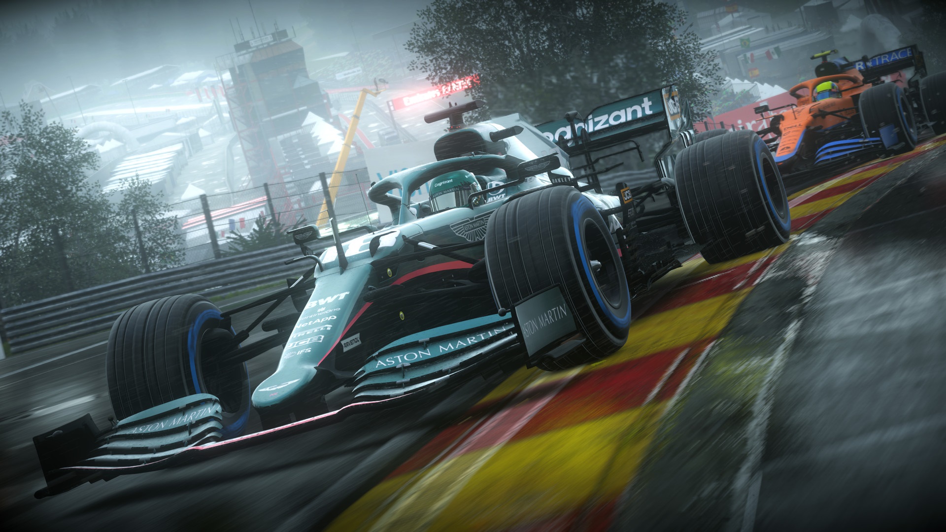 Aston Martin and McLaren F1 cars racing on a wet track HD Wallpaper