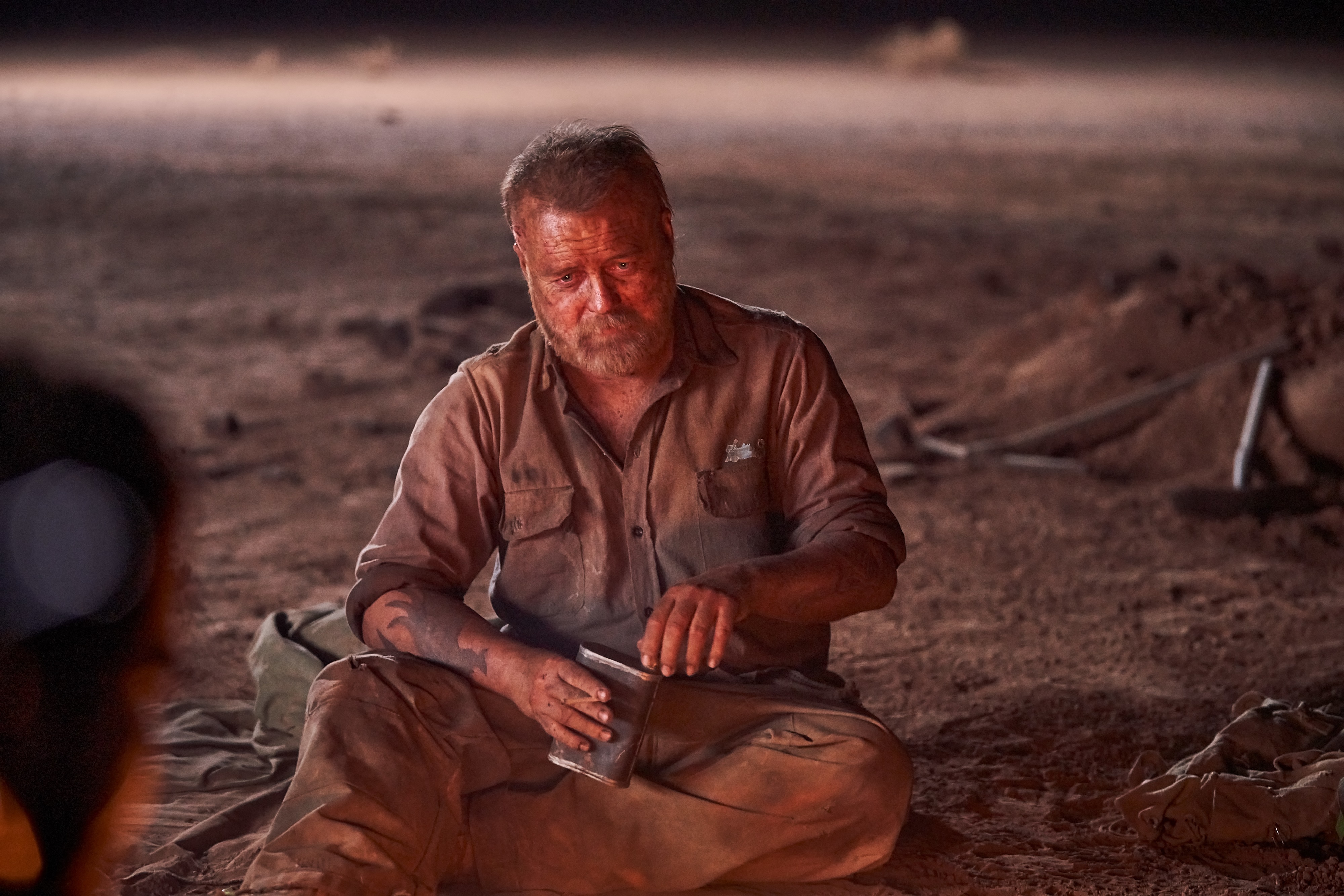 Man in desert holding a metal container HD Wallpaper