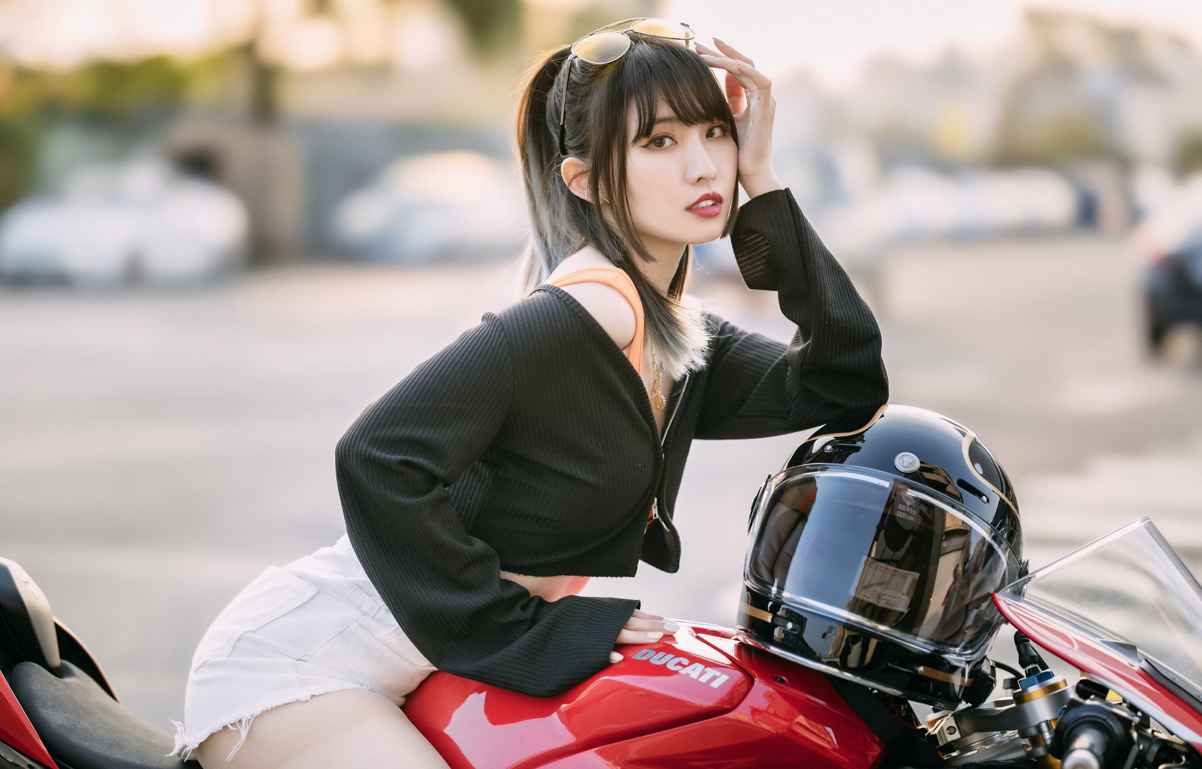 Asian woman posing with a Ducati motorcycle and helmet HD Wallpaper