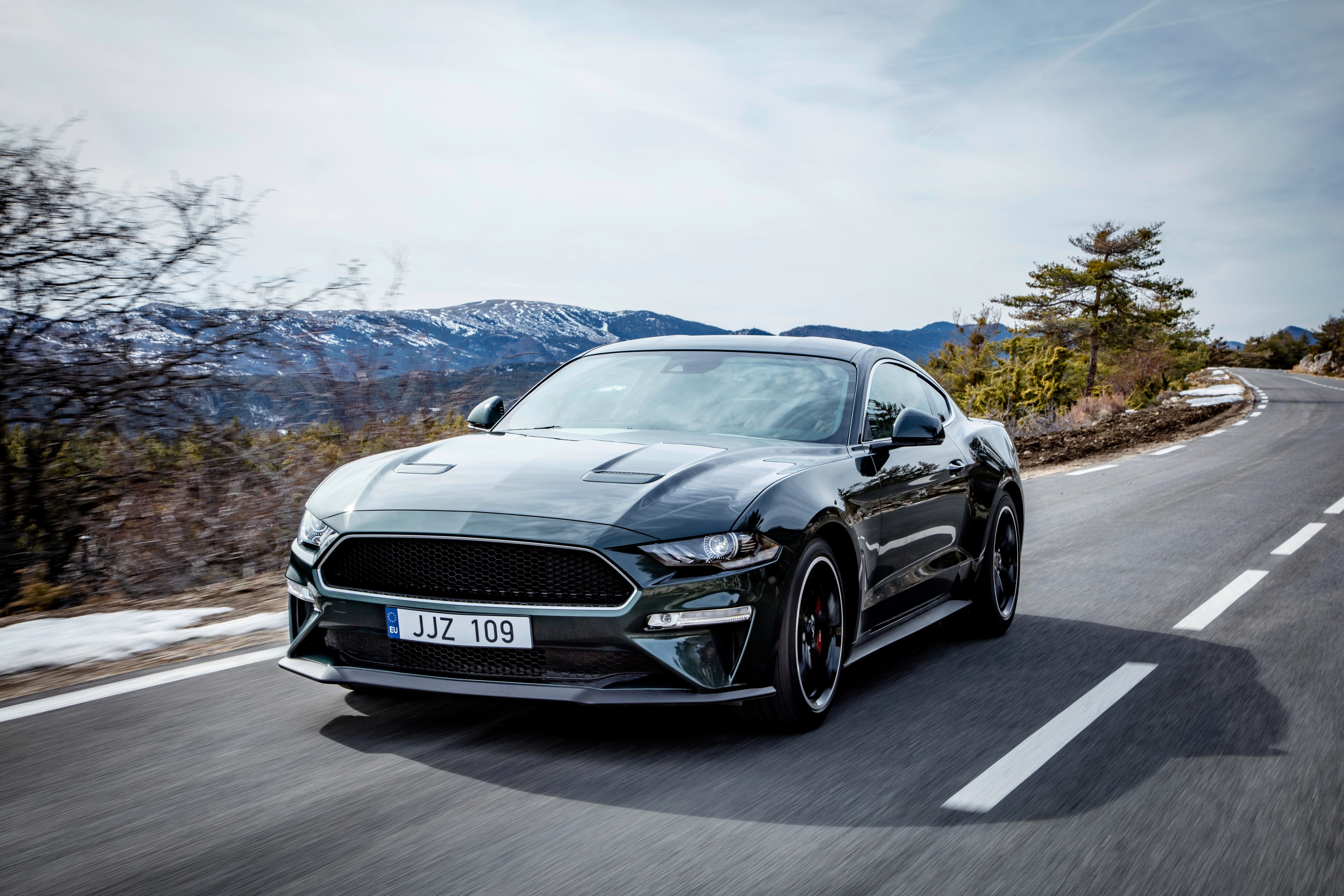 Ford Mustang Bullitt driving on a mountain road HD Wallpaper