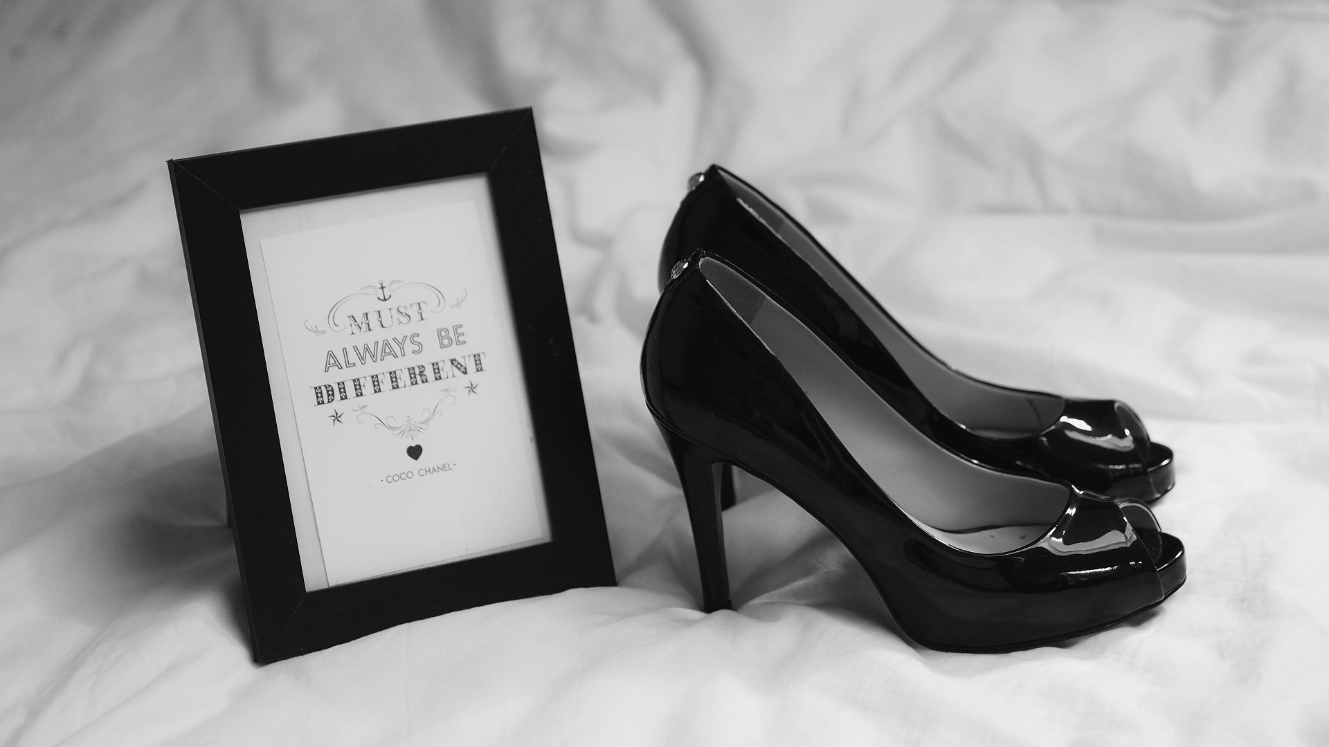 Black peep-toe heels next to a framed quote HD Wallpaper